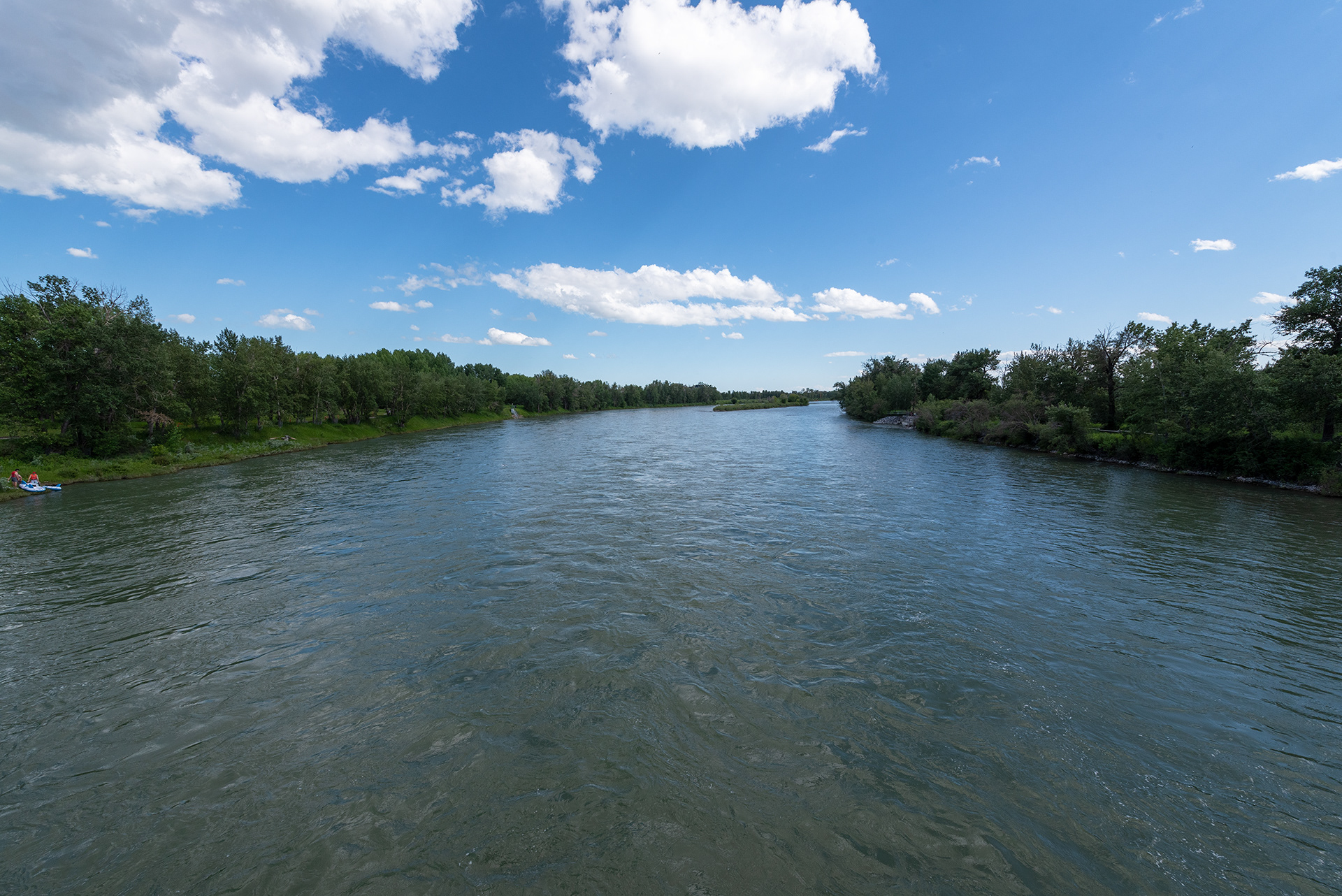 Downstream view of the Bow River from on the Eric Harvie Bridge near Sue Higgins Park, Calgary, Alberta