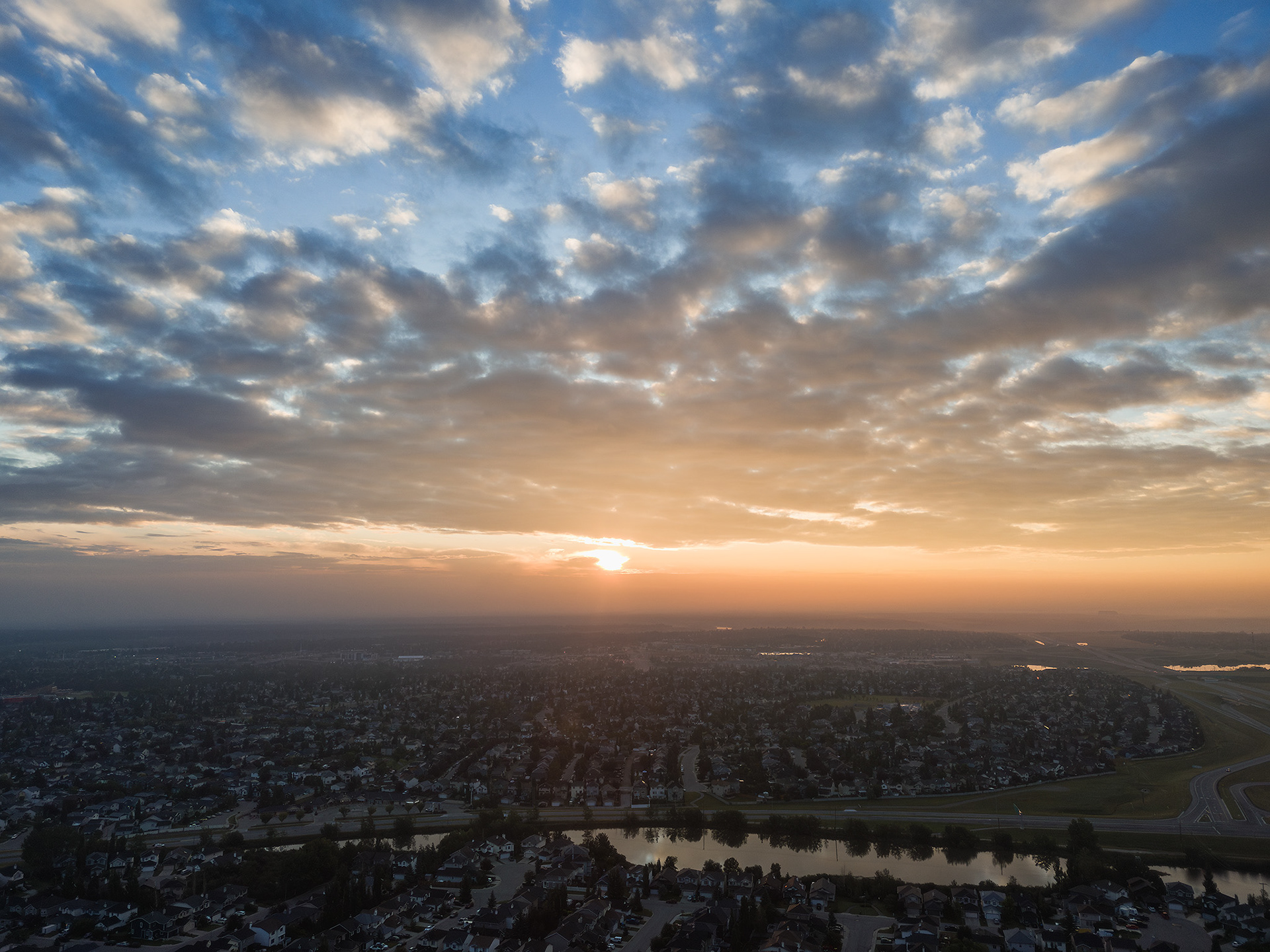 Sunrise aerial photo from over the neighborhood of Bridlewood, Calgary, AB - August 17th