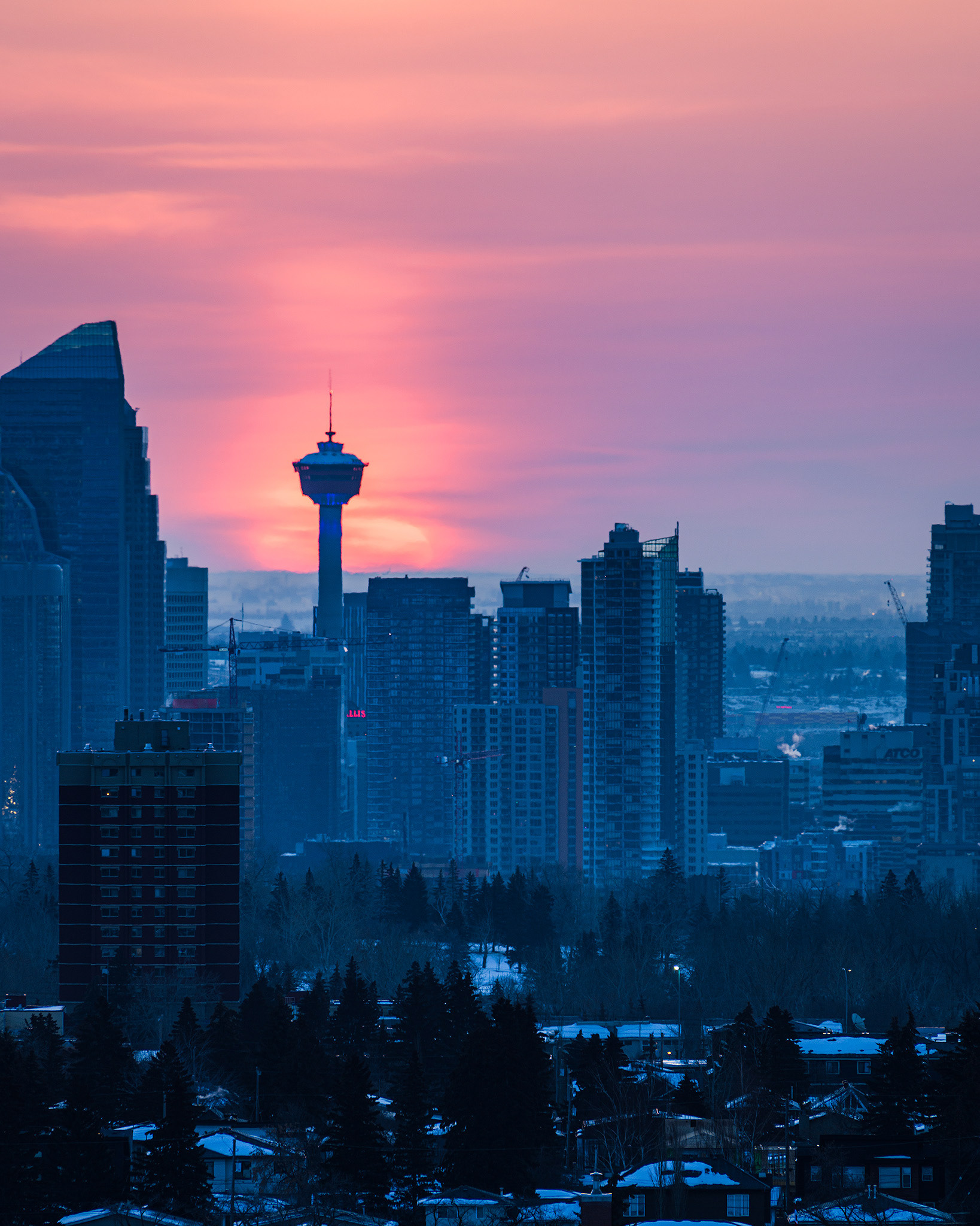 A photo of a portion of the Downtown Calgary skyline at Sunrise, from a park in Strathcona, Calgary, AB - March 19th (7:40 AM, 27 Mp, 4:5 crop)