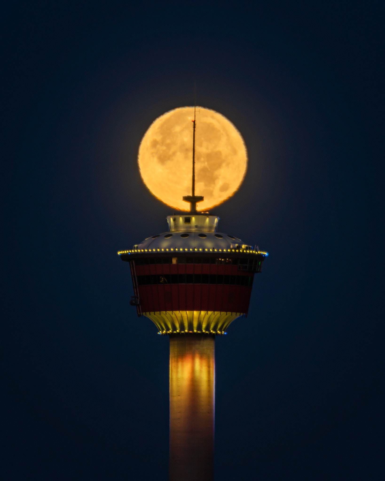 Setting Harvest Moon aligned with the Calgary Tower, from Tom Campbell's Hill Natural Park, Calgary, AB