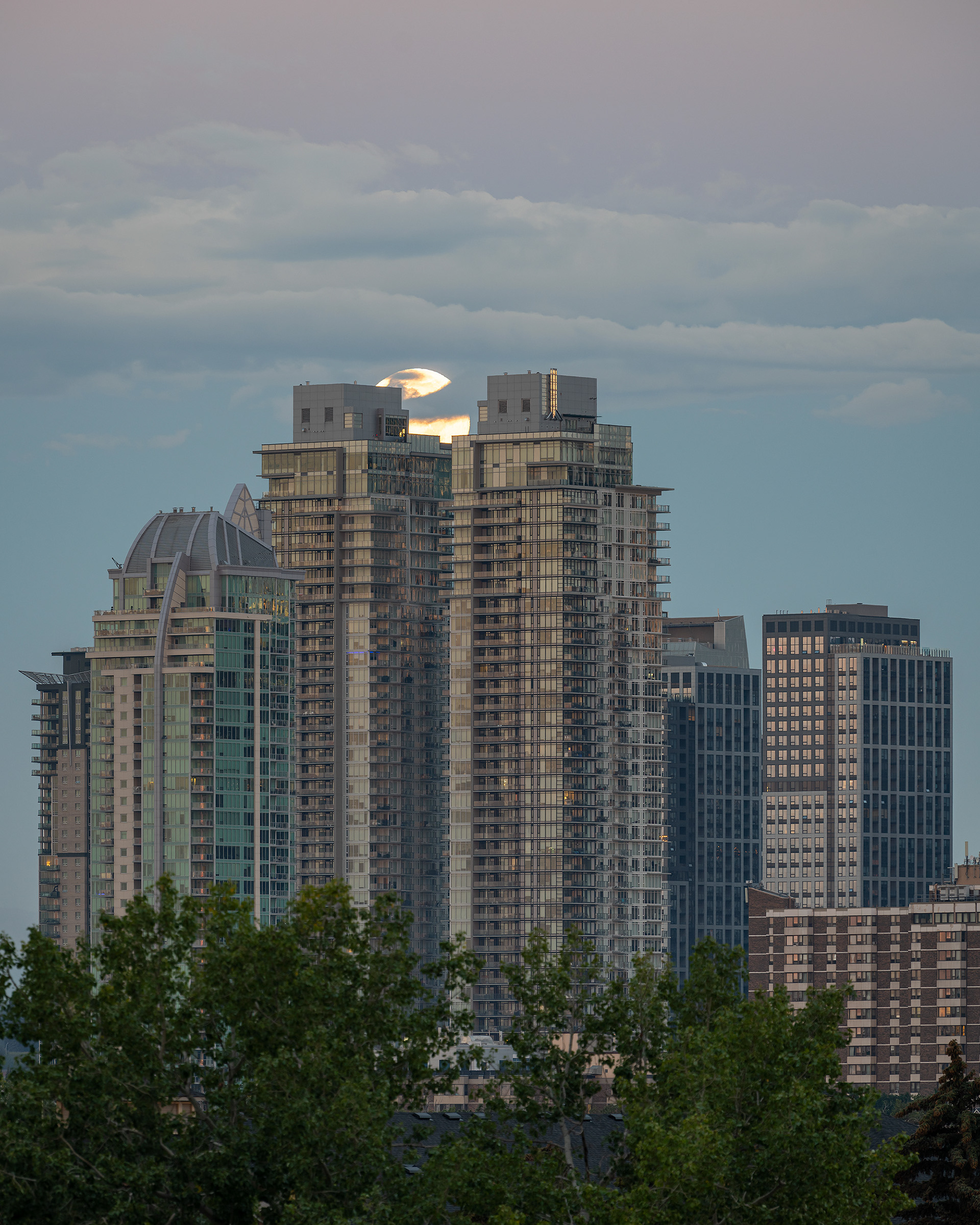 Moonset with some Downtown Calgary East End Buildings, from Tom Campbell's Hill Natural Park, Calgary, AB