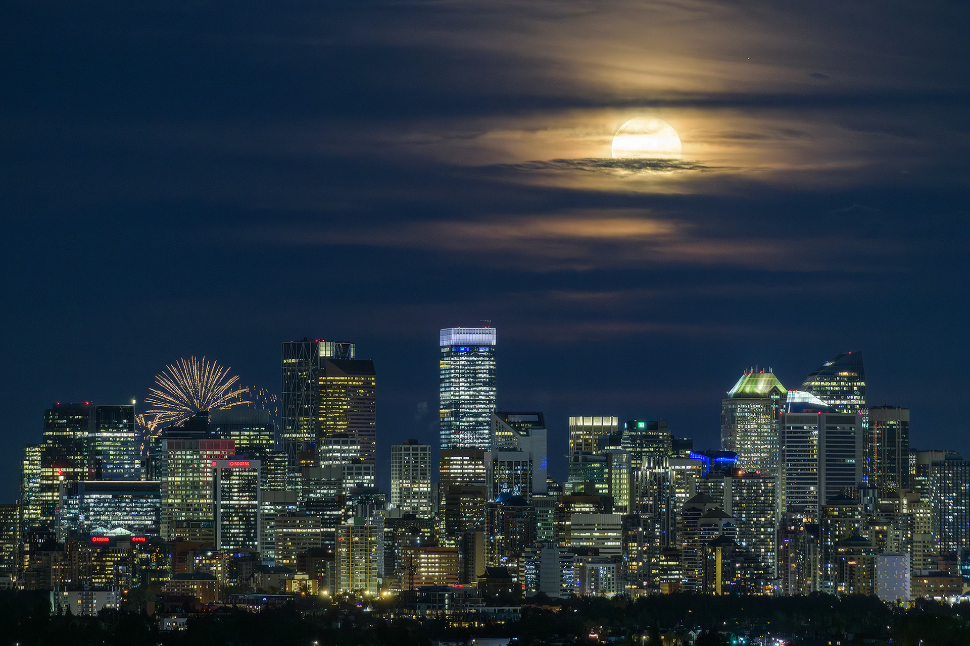 Photo of the Downtown Calgary skyline with rising Sturgeon Moon (one night past at 97.1%), from Edworthy Park, Calgary, AB - August 20th