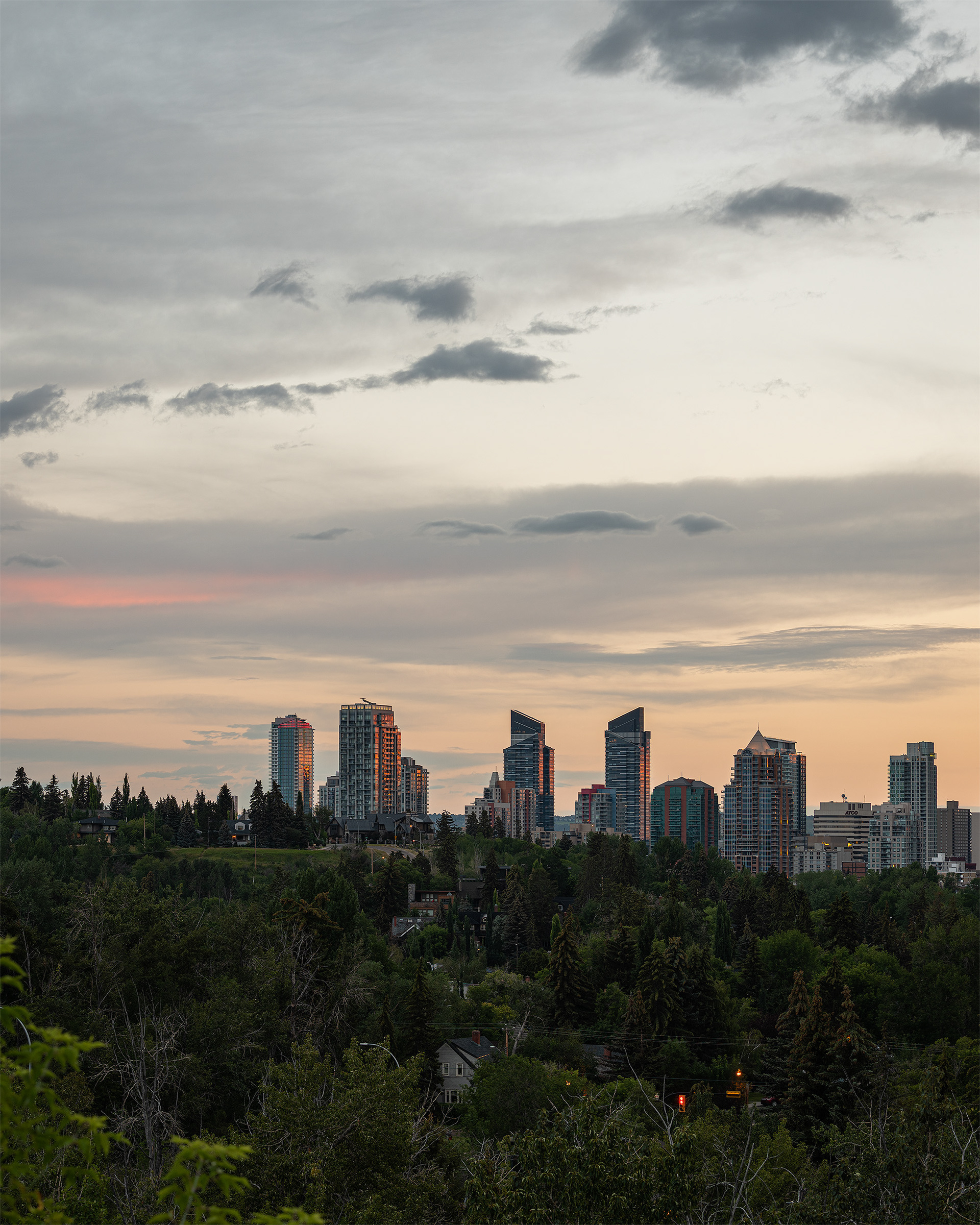 Cityscape of the Downtown Calgary West End skyline at Sunrise, from near Roxboro Park, Calgary, AB