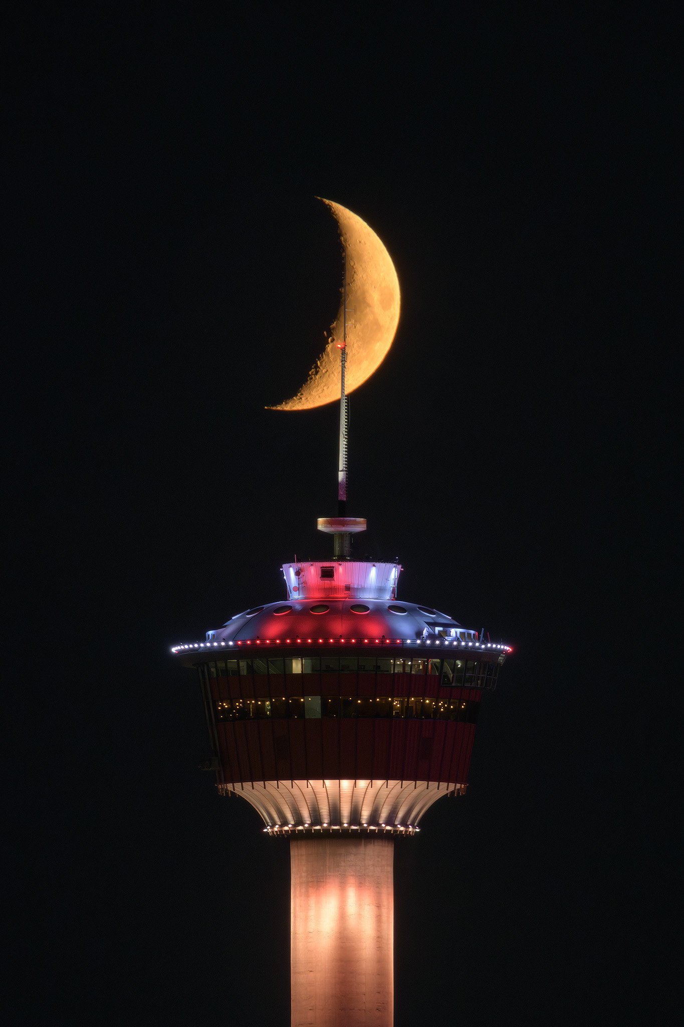 Photo of the Calgary Tower and aligned setting Crescent Moon (Waxing, 24.7%) from 2.4 kms away at Tom Campbell's Hill, Calgary, AB - August 9th