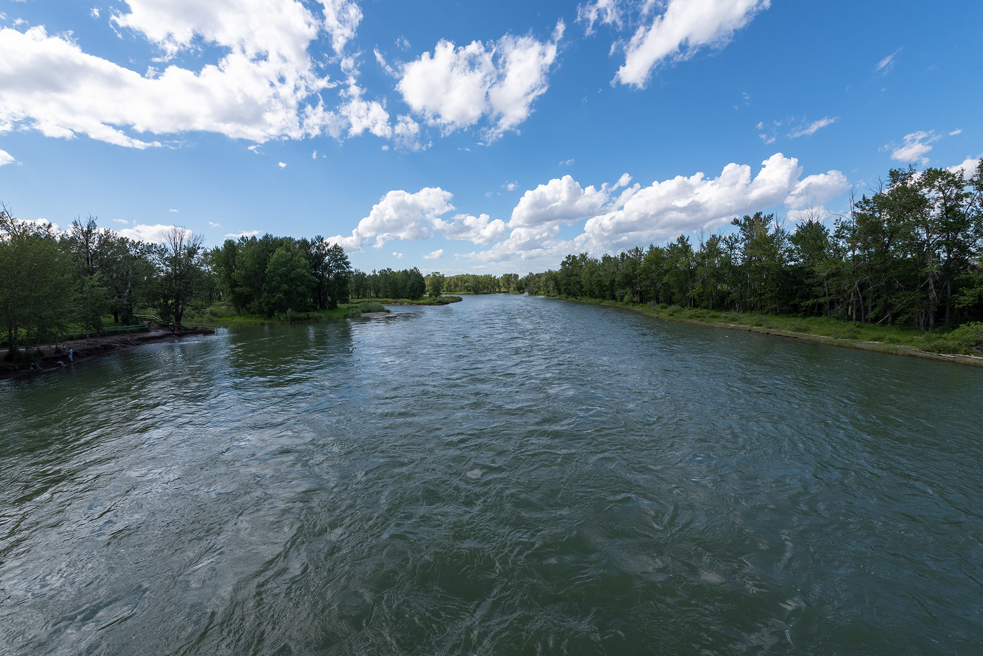 Upstream view of the Bow River from on the Eric Harvie Bridge near Sue Higgins Park, Calgary, Alberta