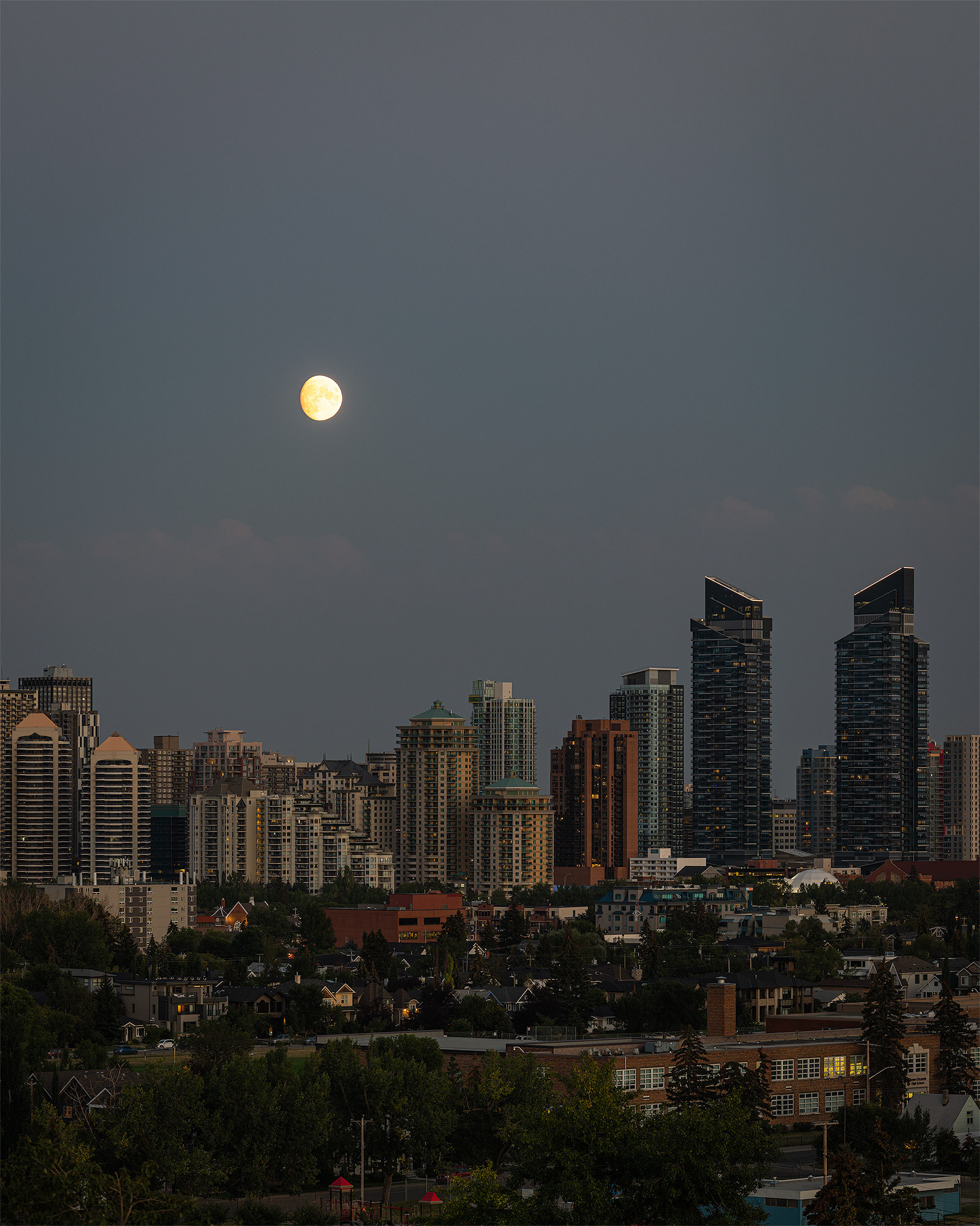 4x5 Cityscape of the Downtown West End Calgary skyline at Sunset/Moonrise, from West Hillhurst off-leash area (Grasshopper Hill), Calgary, AB
