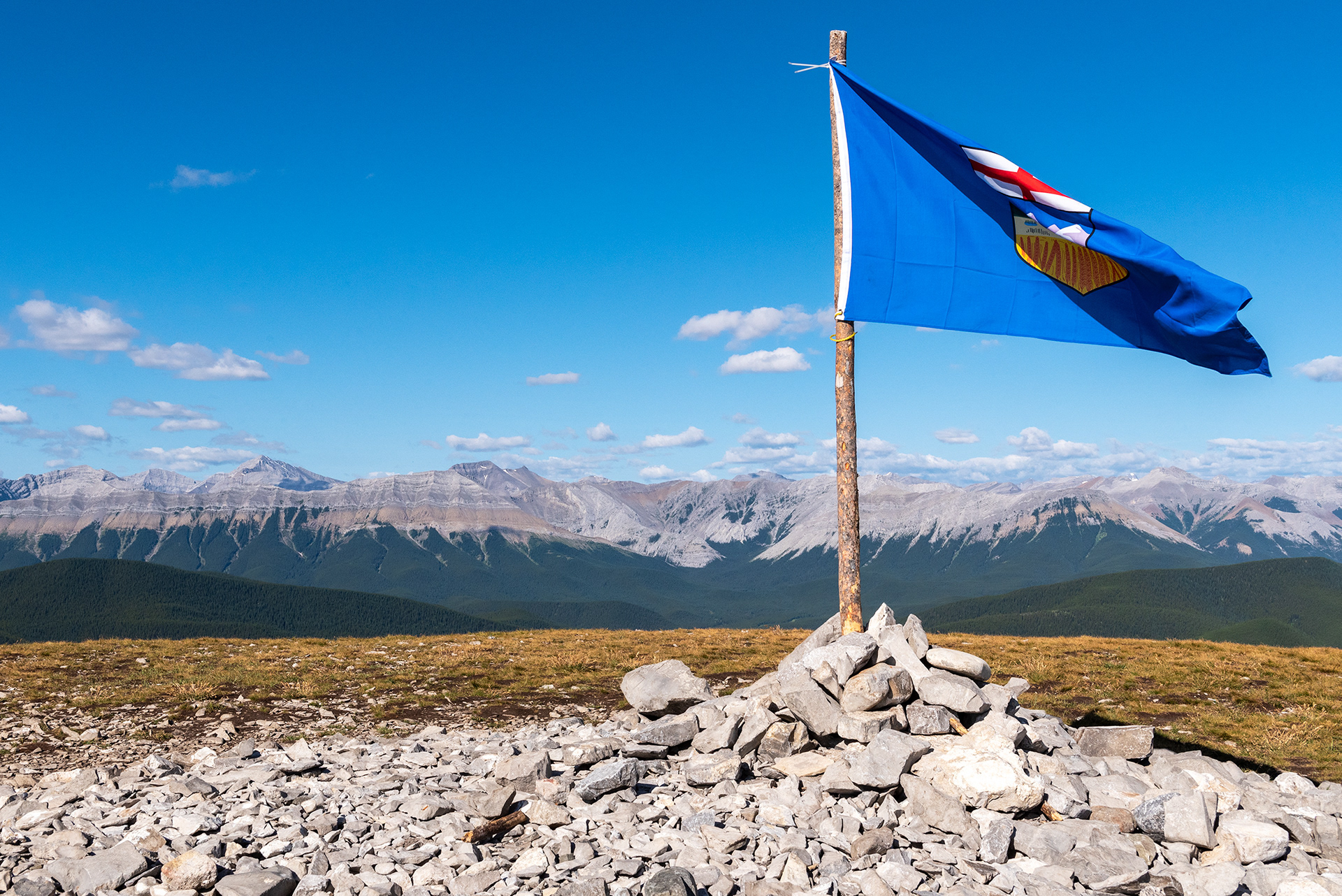 A view with the flag of Alberta (at the peak of Prairie Mountain)