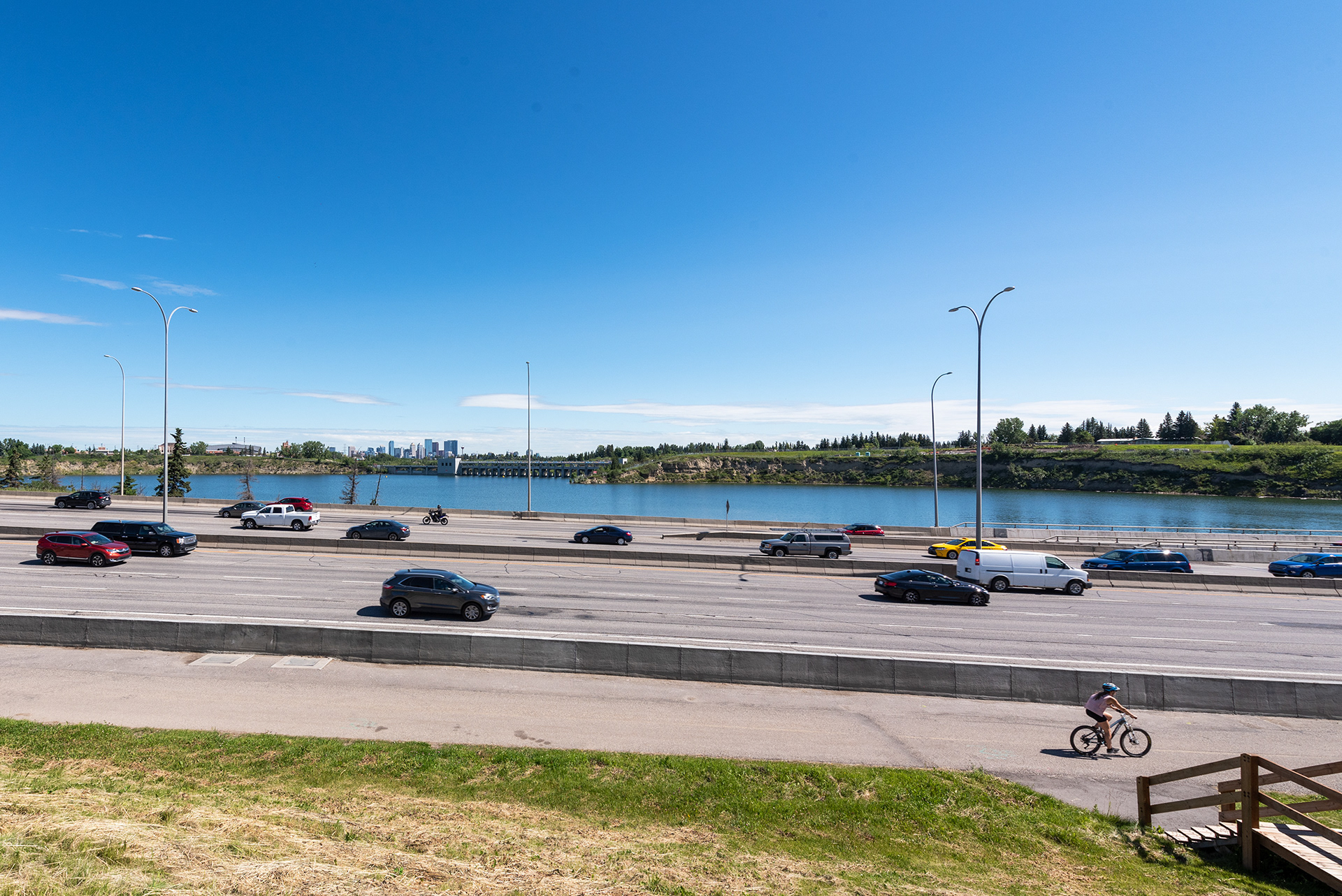 View of the Glenmore Reservoir, and Dam, across Glenmore Trail SW (Highway 8), from near the Glenmore Causeway Bridge
