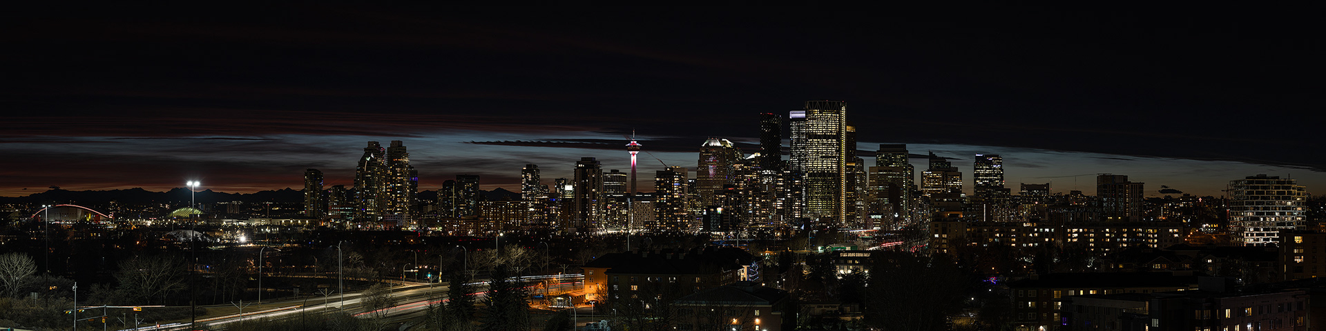 4x1 Panoramic Cityscape (11 shot) of the downtown skyline [post sunset, Nautical Twilight (sun altitude -10 degrees)] from Tom Campbell's Hill Natural Park, Calgary, AB