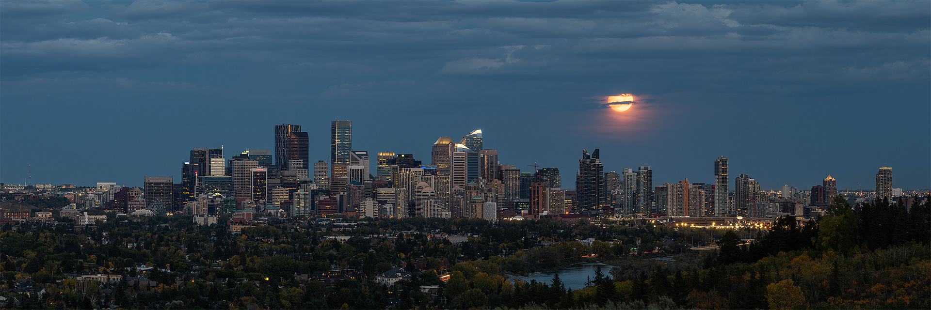 Panoramic Cityscape (post sunset) with full moon rise, from Edworthy Park, Calgary, Alberta