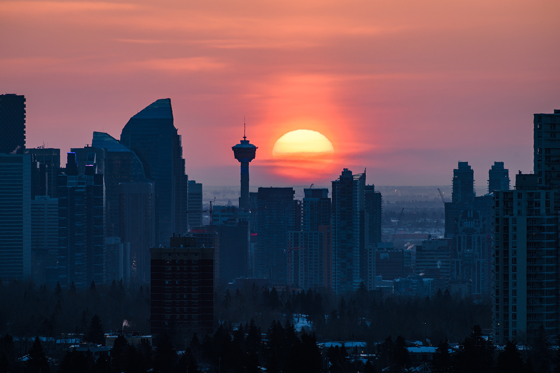 A photo of a portion of the Downtown Calgary skyline at Sunrise, from a park in Strathcona, Calgary, AB - March 19th (7:43 AM, 40 Mp)