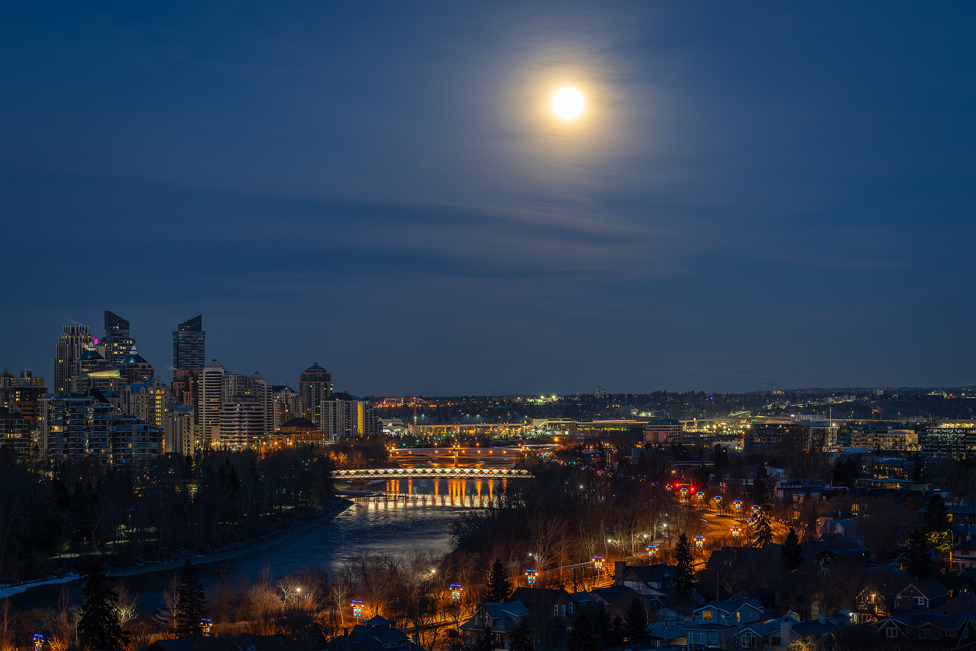 3x2 Cityscape (2 shot) of the Peace Bridge, Bow River, Memorial Dr., setting Moon, and a portion of the downtown skyline, [pre sunrise, Nautical Twilight (sun altitude -7.6 degrees)], from Crescent Heights Lookout Point, Calgary, AB
