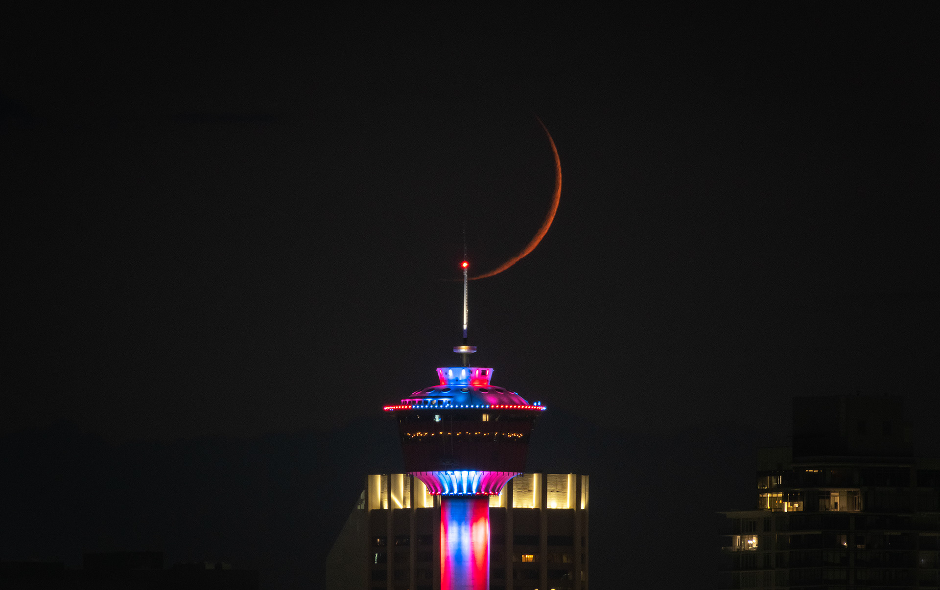 16x9 Cityscape of the Calgary Tower and setting Waxing Crescent Moon, from Southview Off Leash Dog Park, Calgary, AB