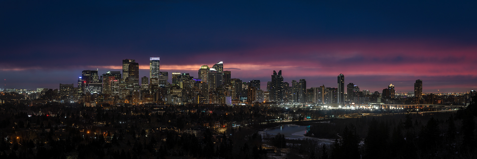 3x1 Panoramic Cityscape (8 shot) of the downtown skyline [pre sunrise, Nautical Twilight (sun altitude -7.2 degrees)] from Edworthy Park, Calgary, AB