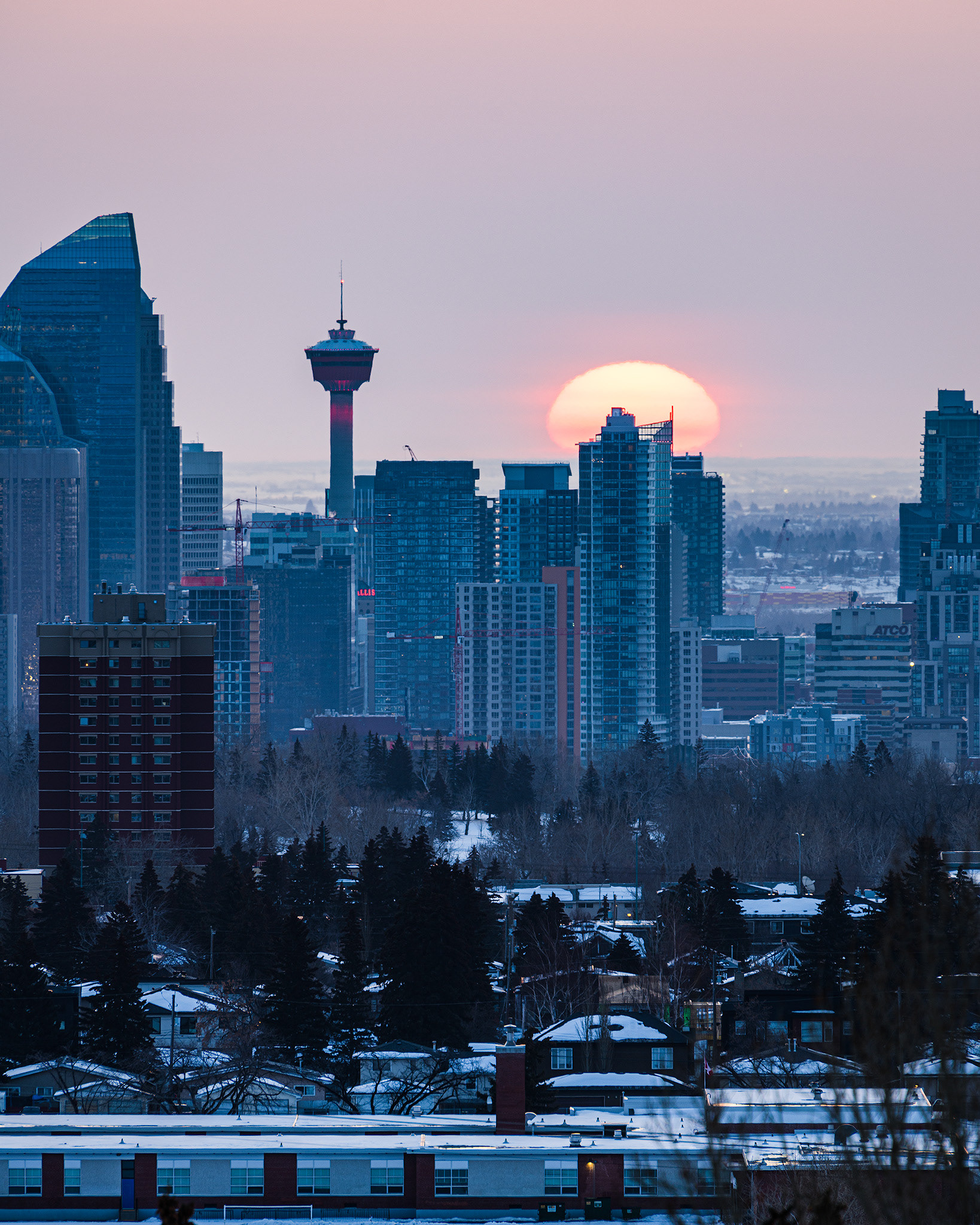 A photo of a portion of the Downtown Calgary skyline at Sunrise, from a park in Strathcona, Calgary, AB - March 18th (7:44 AM, 30 Mp, 4:5 crop)
