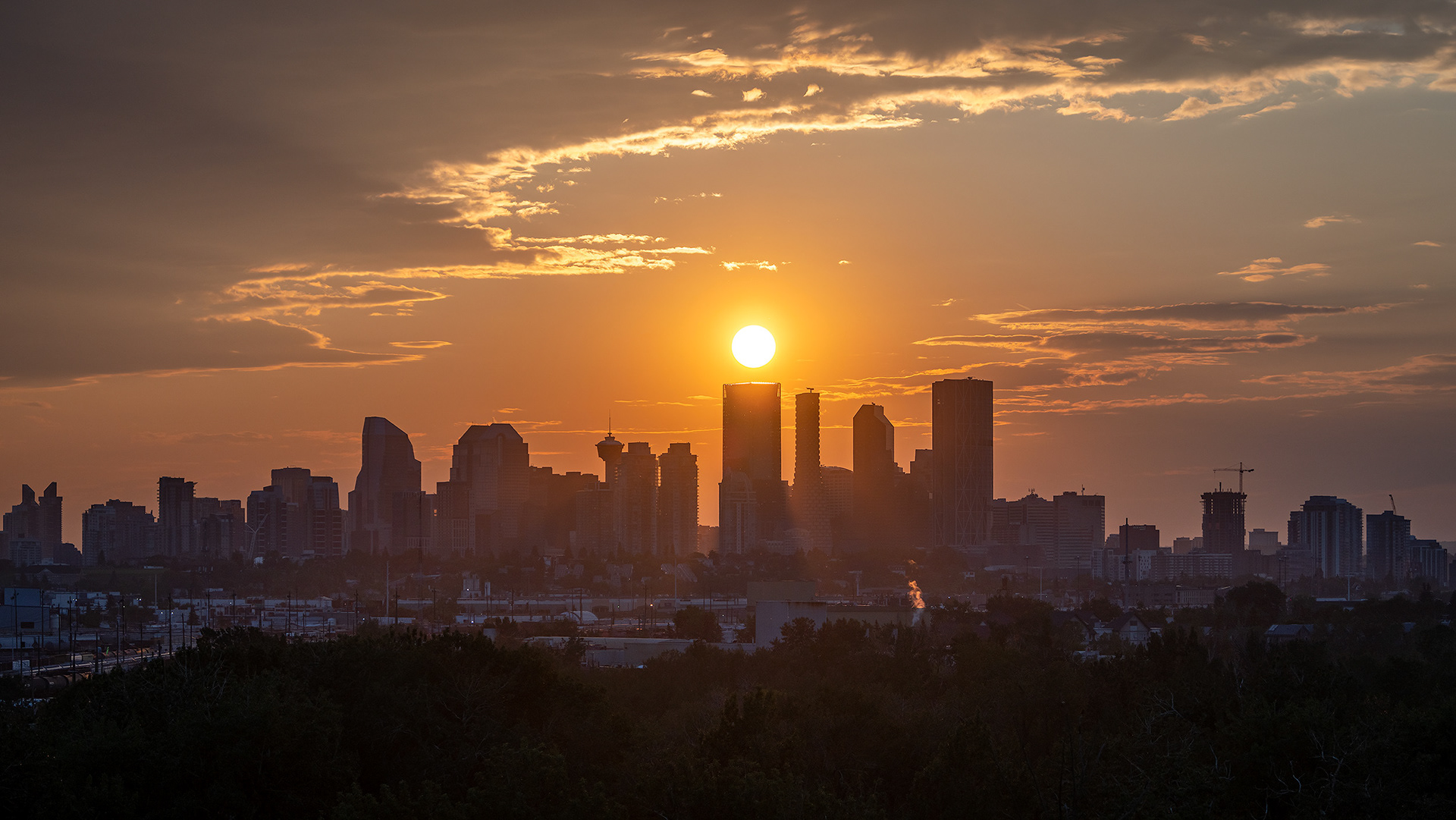 16x9 Cityscape of the downtown skyline at Sunset, from Southview Off Leash Dog Park, Calgary, AB
