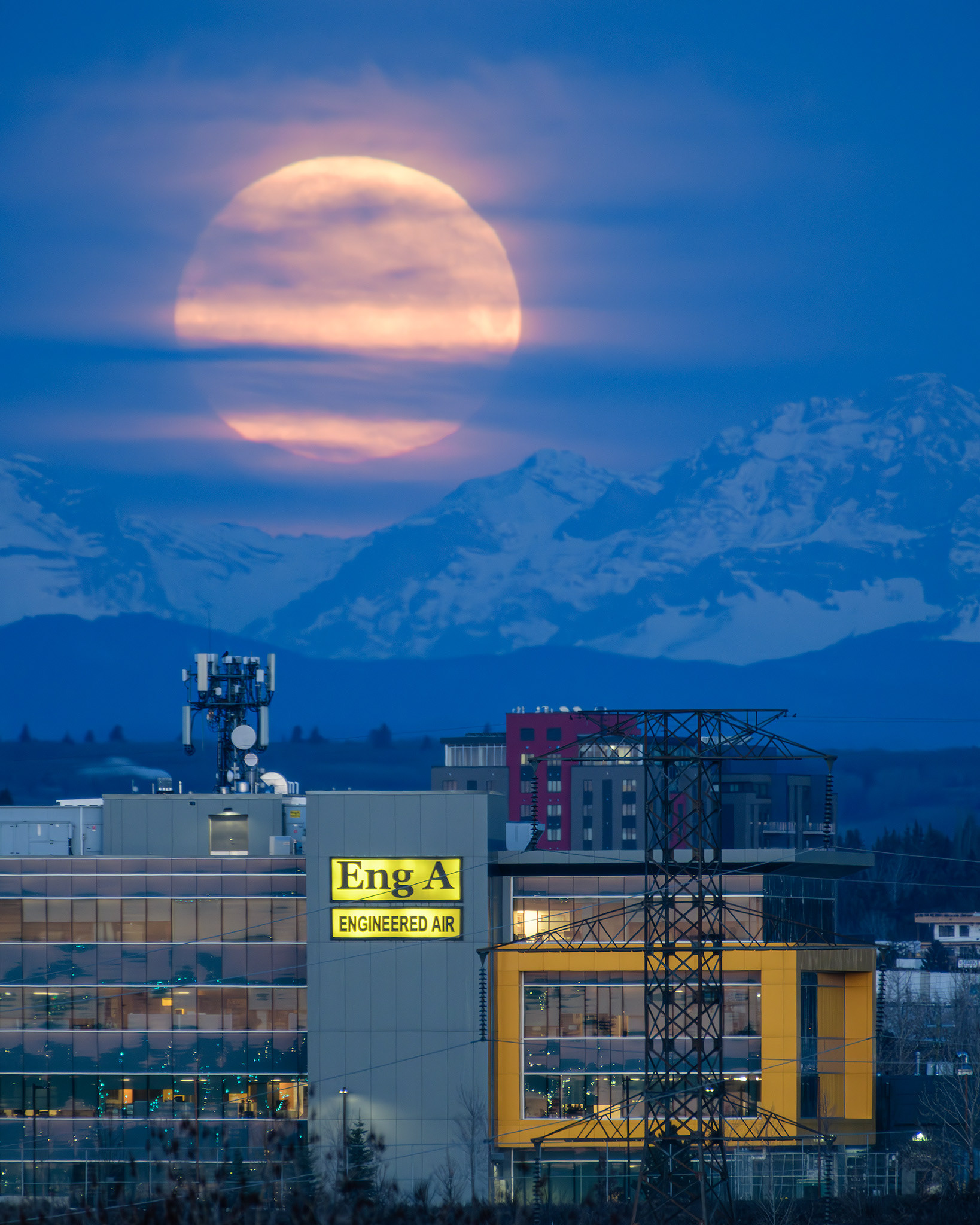 A photo of the Moon setting beyond the Rocky Mountains during Civil Twilight, from Southview Off Leash Dog Park, Calgary, AB - April 23rd
