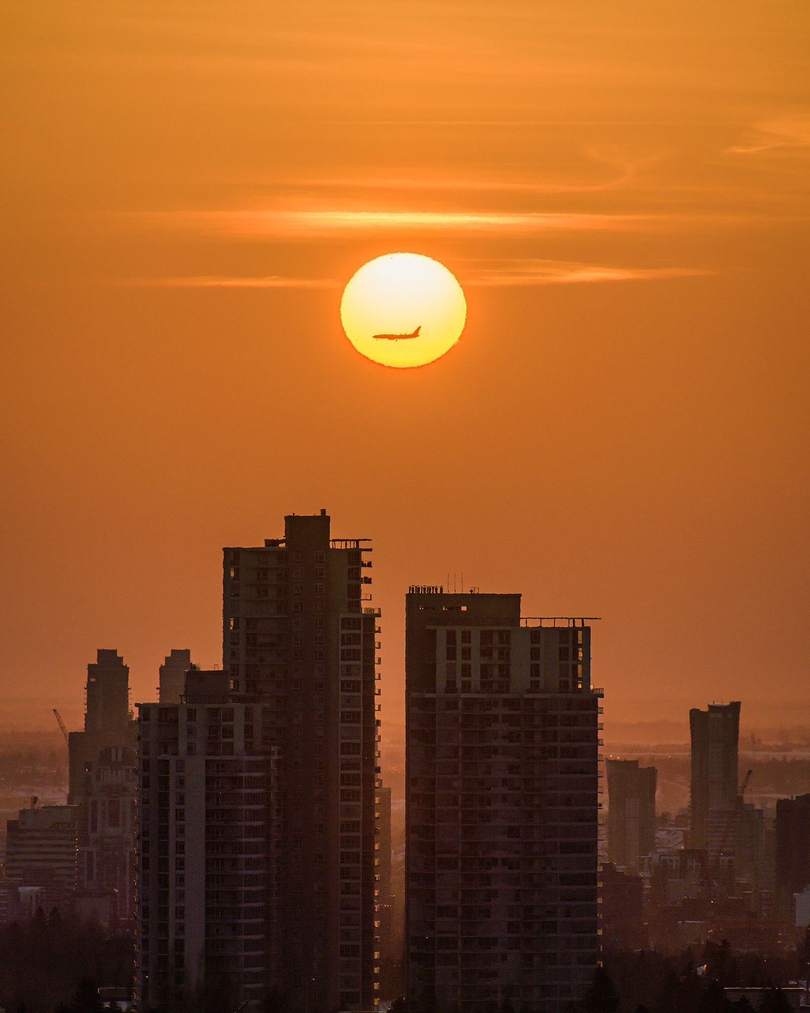 A photo of the Encore Condominiums at Sunrise, from a park in Strathcona, Calgary, AB - March 18th (7:55 AM, 37 Mp, 4:5 crop)