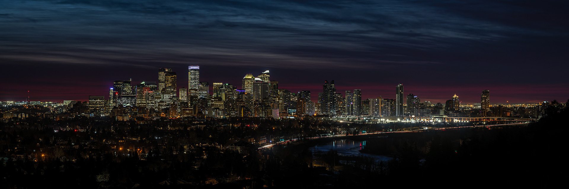 3x1 Panoramic Cityscape (8 shot) of the downtown skyline [pre sunrise, Nautical Twilight (sun altitude -10.6 degrees)] from Edworthy Park, Calgary, AB