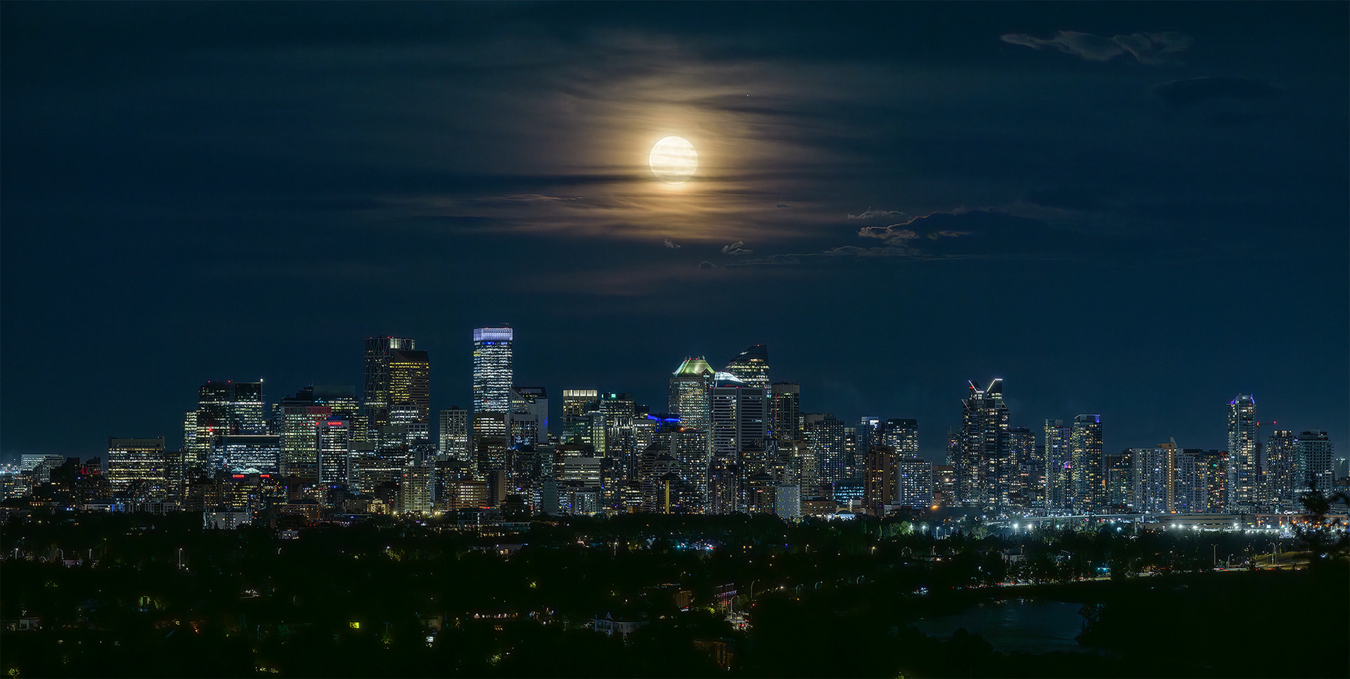 Photo of the Downtown Calgary skyline with rising Sturgeon Moon (one night past at 97.1%), from Edworthy Park, Calgary, AB - August 20th