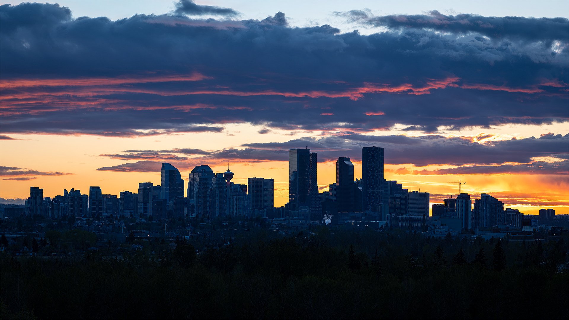 16x9 Panoramic Cityscape (5 shot) of the downtown skyline [Sunset (sun altitude -0.1 degree)] from near Valleyview Park, Calgary, AB