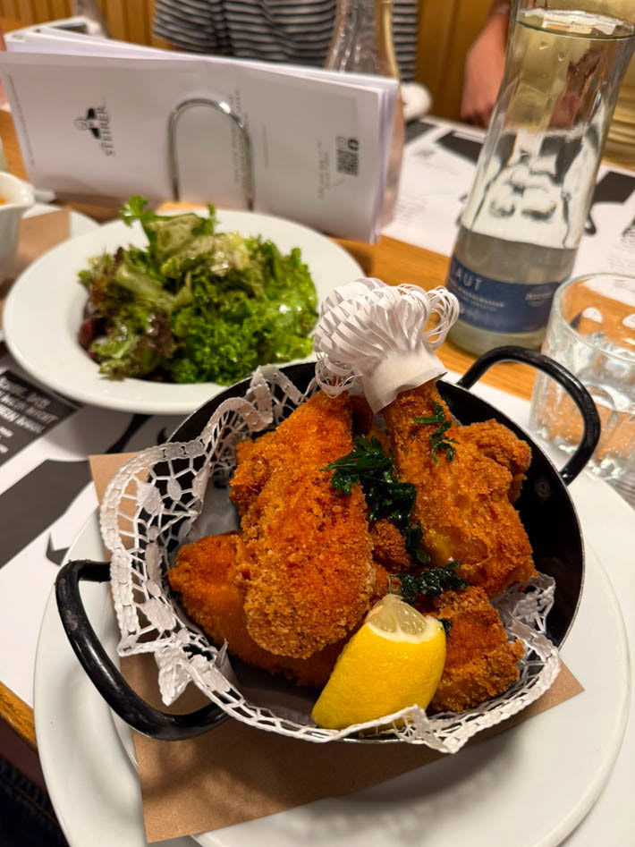 photo of Backhendl and salad at restaurant Der Steirer in Graz. By Bianca Gschlecht