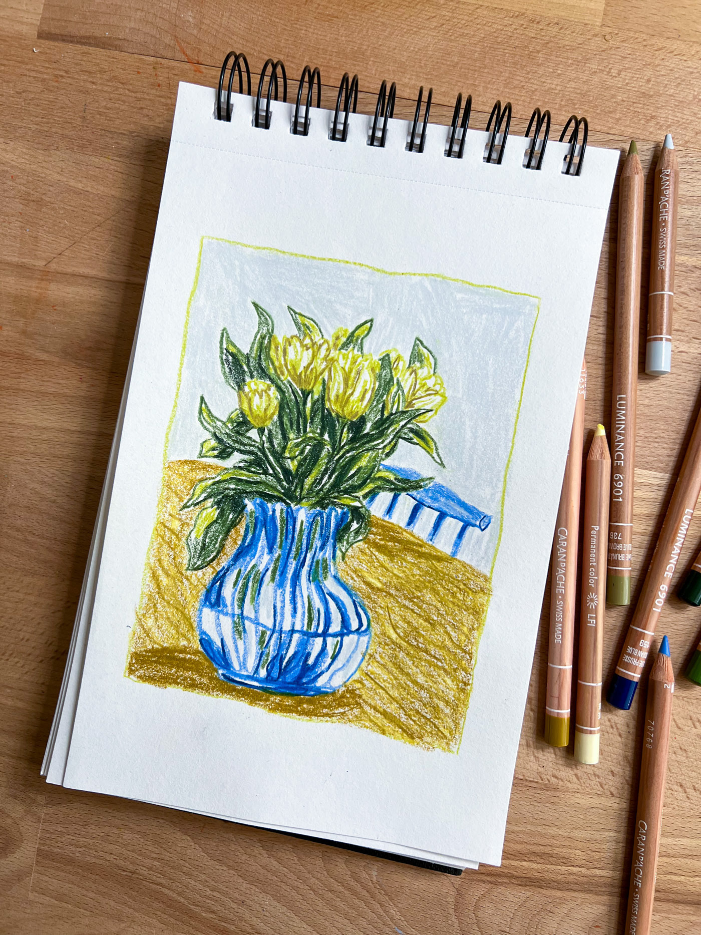 photo of a lifestyle illustration sketch showing tulips on a table and a hay chair in the back. By Bianca Gschlecht