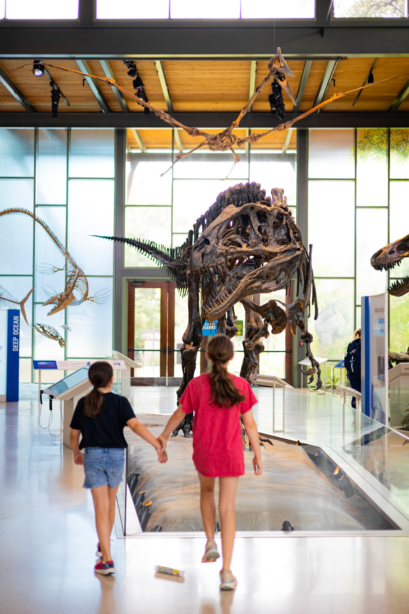 Sisters hold hands as they begin to explore the Witte Museum in San Antonio, Texas on June 30th, 2023.