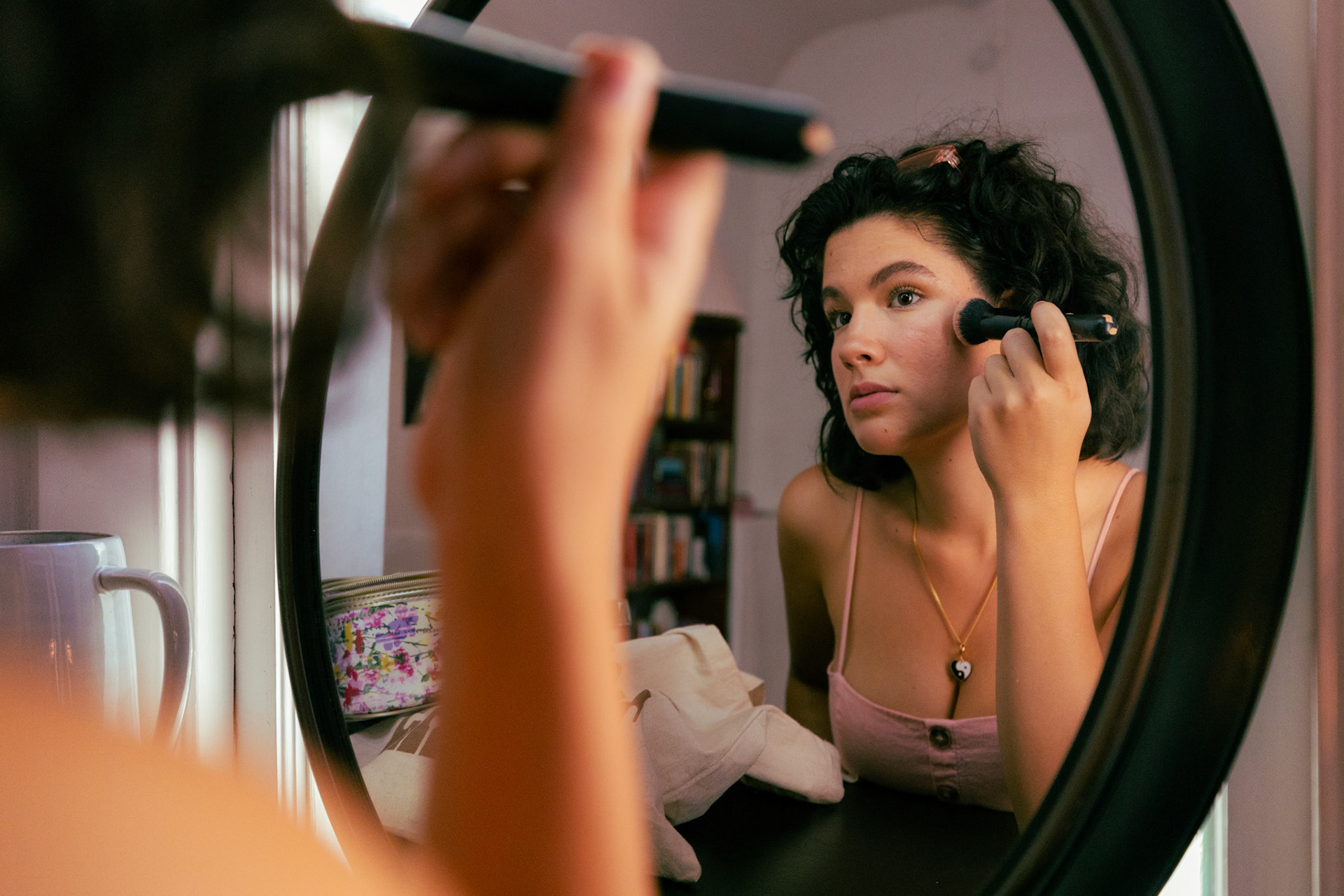 Ana Lacau applying makeup at her house in Austin, Texas on August 29th, 2023.