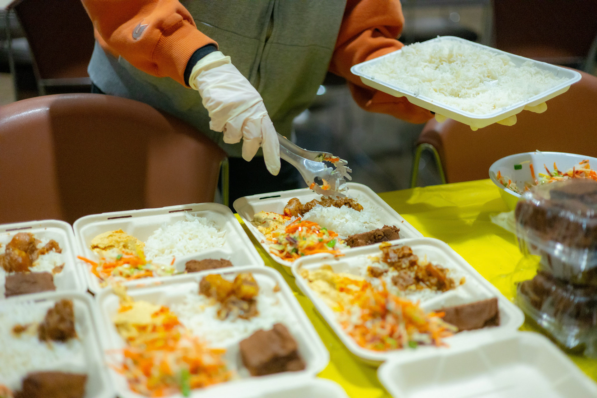 Members of the West Campus Collective prepare to go boxes using leftover food from the Hillel Community Center in Austin, Texas on Feb. 27th, 2024.