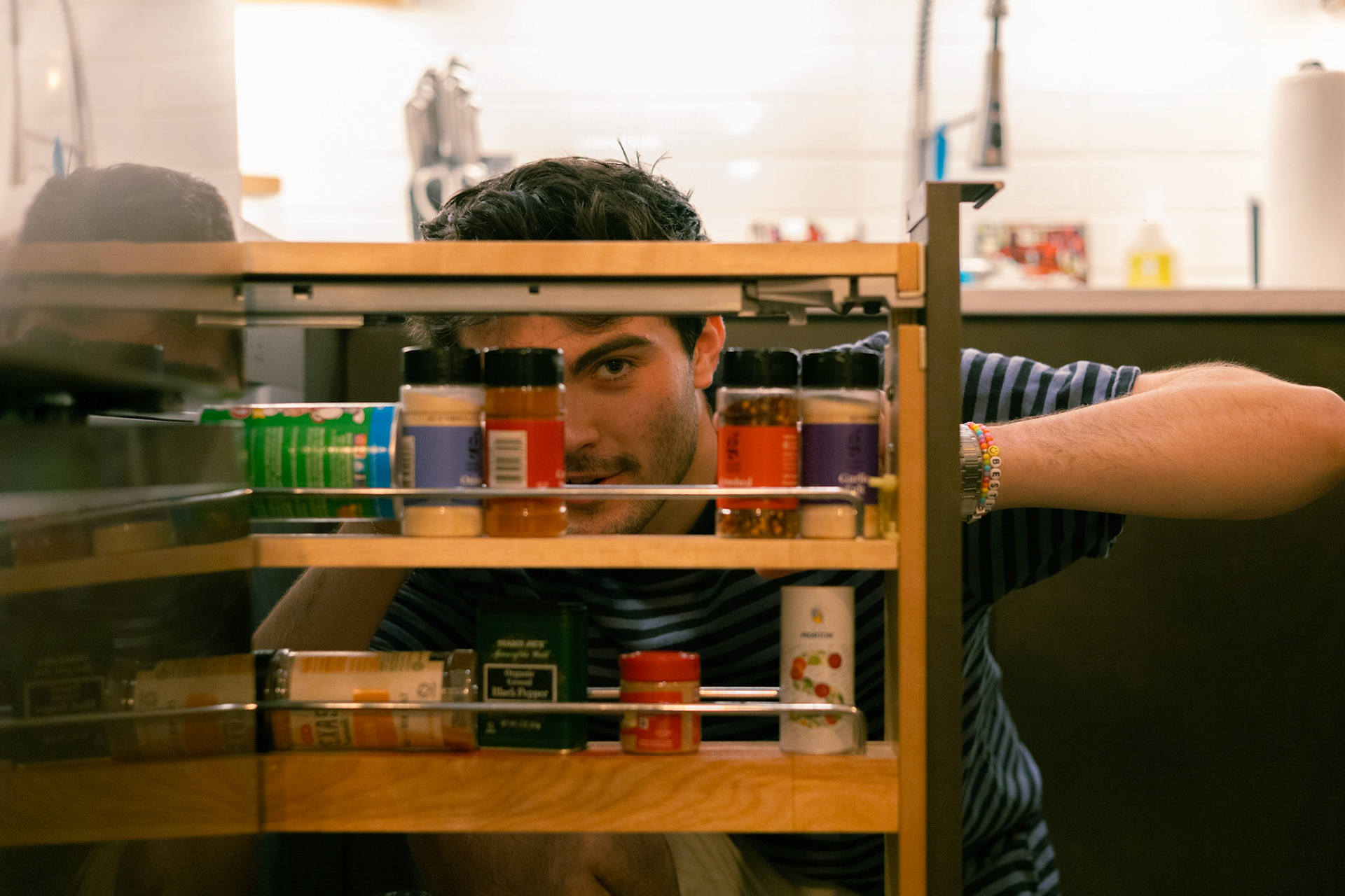 Walker Young perusing through his spice rack contemplating the flavor of the night. Austin, Tx, September 7th, 2023.