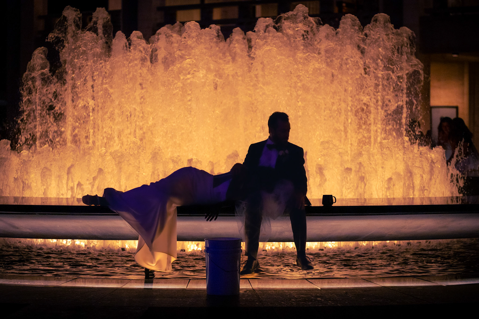 A recently married couple rest at the Lincoln Center Fountain in New York City on August 18th, 2023.