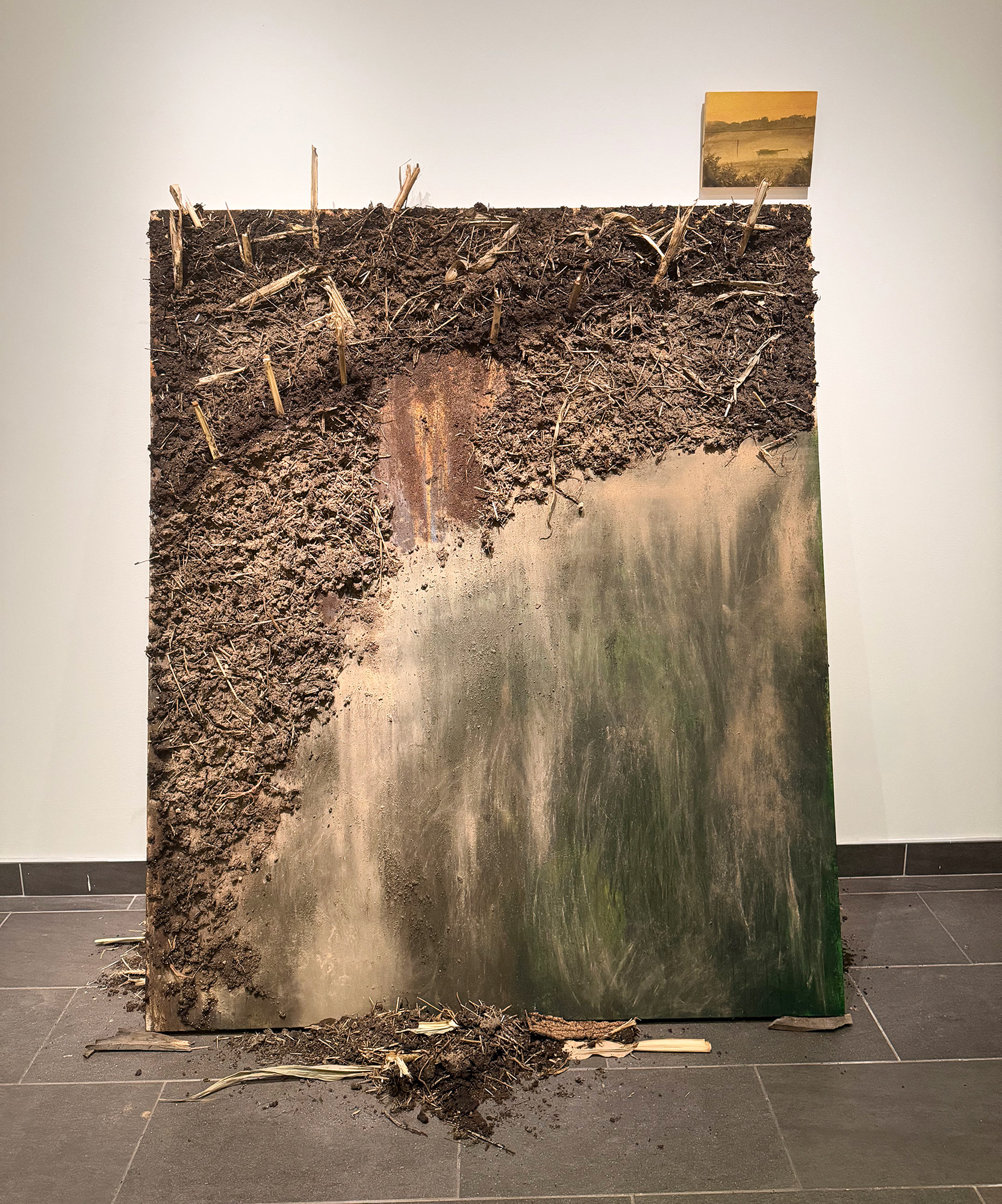 "End Row", 2026, acrylic, soil, roots, tree bark, and corn stalks on canvas, 72" x 56"