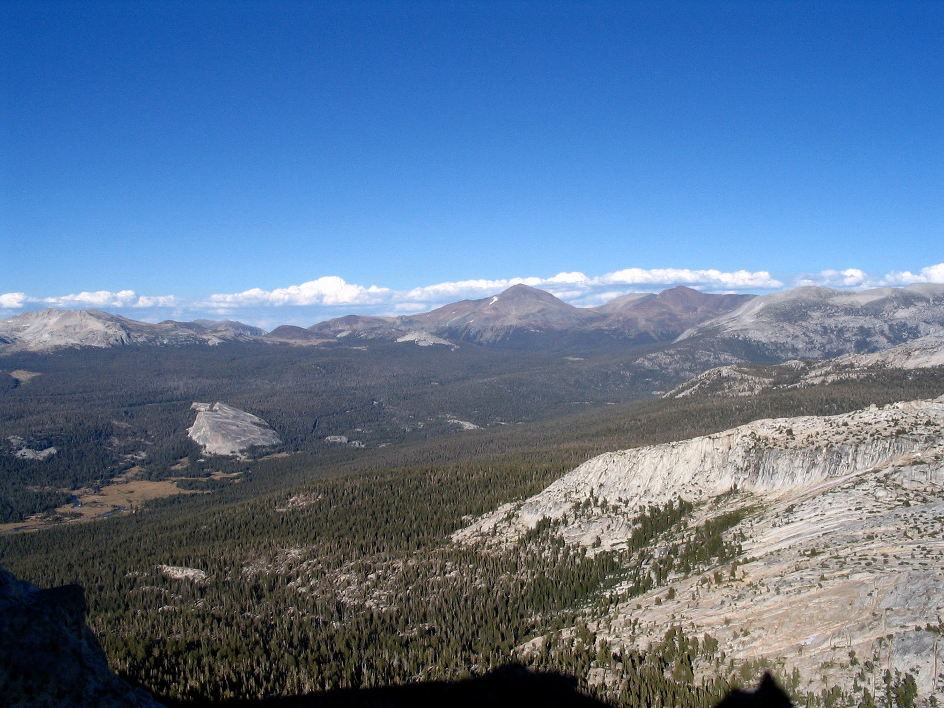 View of the valley below, with the shadow of Cathedral Peak