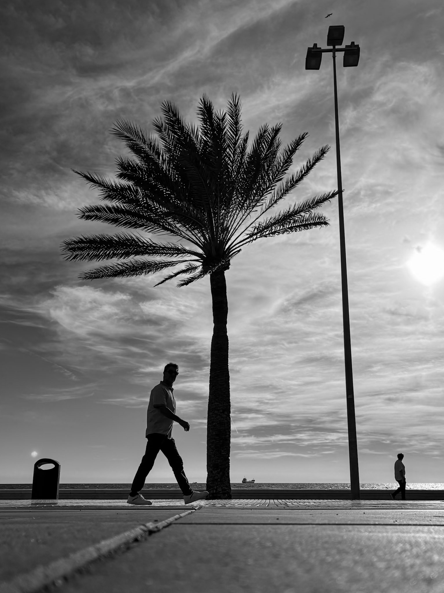 A man strolls along the seafront in Almeria City, southern Spain.