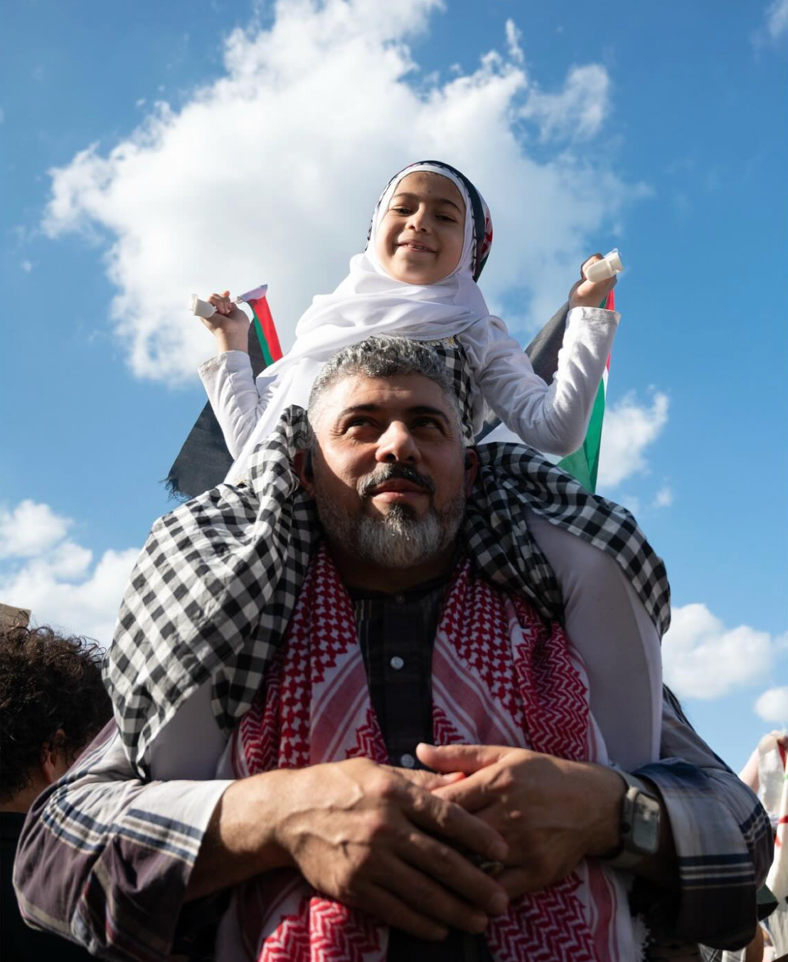 A father and daughter attend a march calling for a ceasefire in Gaza at Mill Creek Park in Kansas City, Missouri on May 18, 2024.