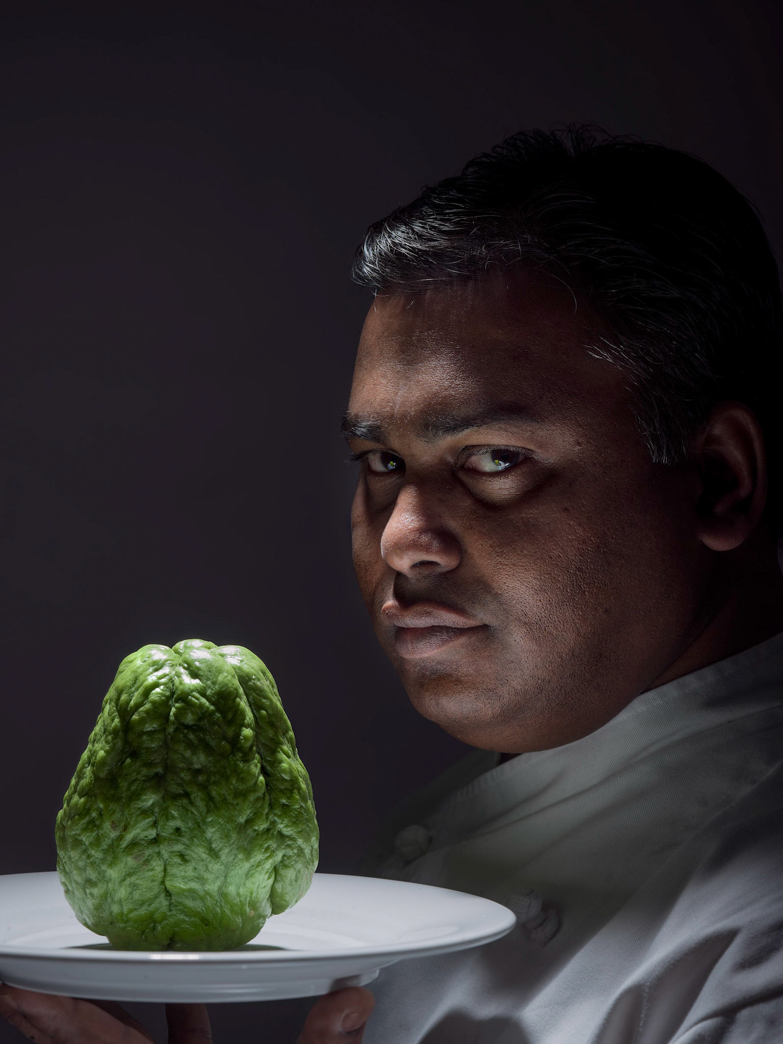 Kavi Hurrydoss is a Mauritian chef based on the Central Coast of NSW, and the executive chef of L’isle de France restaurant in Terrigal. The restaurant serves mostly French inspired dishes, but Kavi also will prepare traditional Mauritian cuisine from time to time.The vegetable he is holding is a Choko or Chayote, something that is often used in traditional Mauritian food. Kavi’s approach to cooking is to preserve the essential flavour of the main ingredient to let the diner appreciate the food at it’s best, while highlighting it’s different qualities, balancing the flavours with the other ingredients.I decided to show the concept of his approach to cooking by having him serving the Choko raw, conveying the purity of the flavours in his dishes.