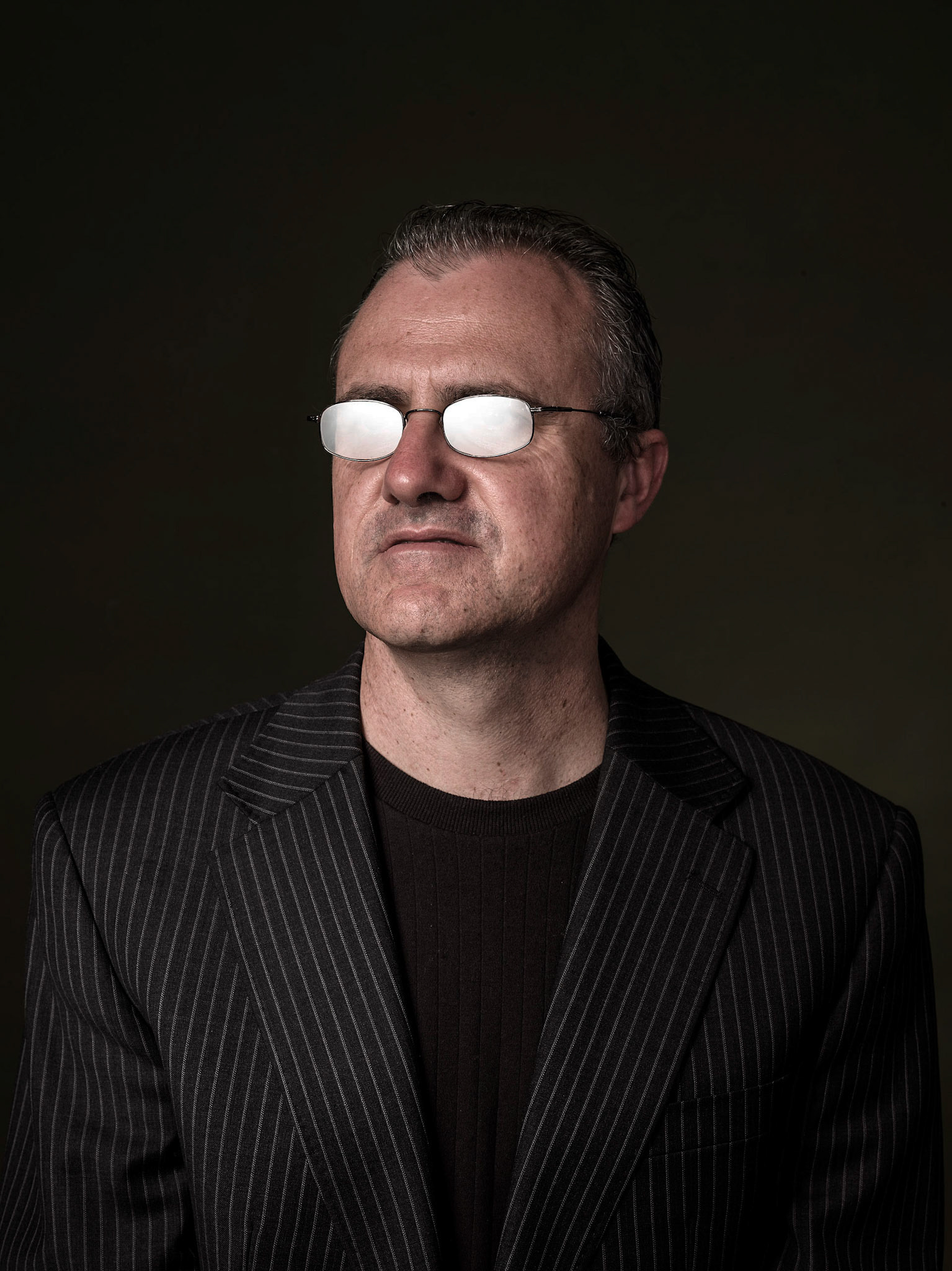 In playback theater the audience volunteer their own life stories to the players who then interpret their stories and perform them back to the audience, here a playback performer waits to hear a story, a blank waiting to reflect back someones else's life.