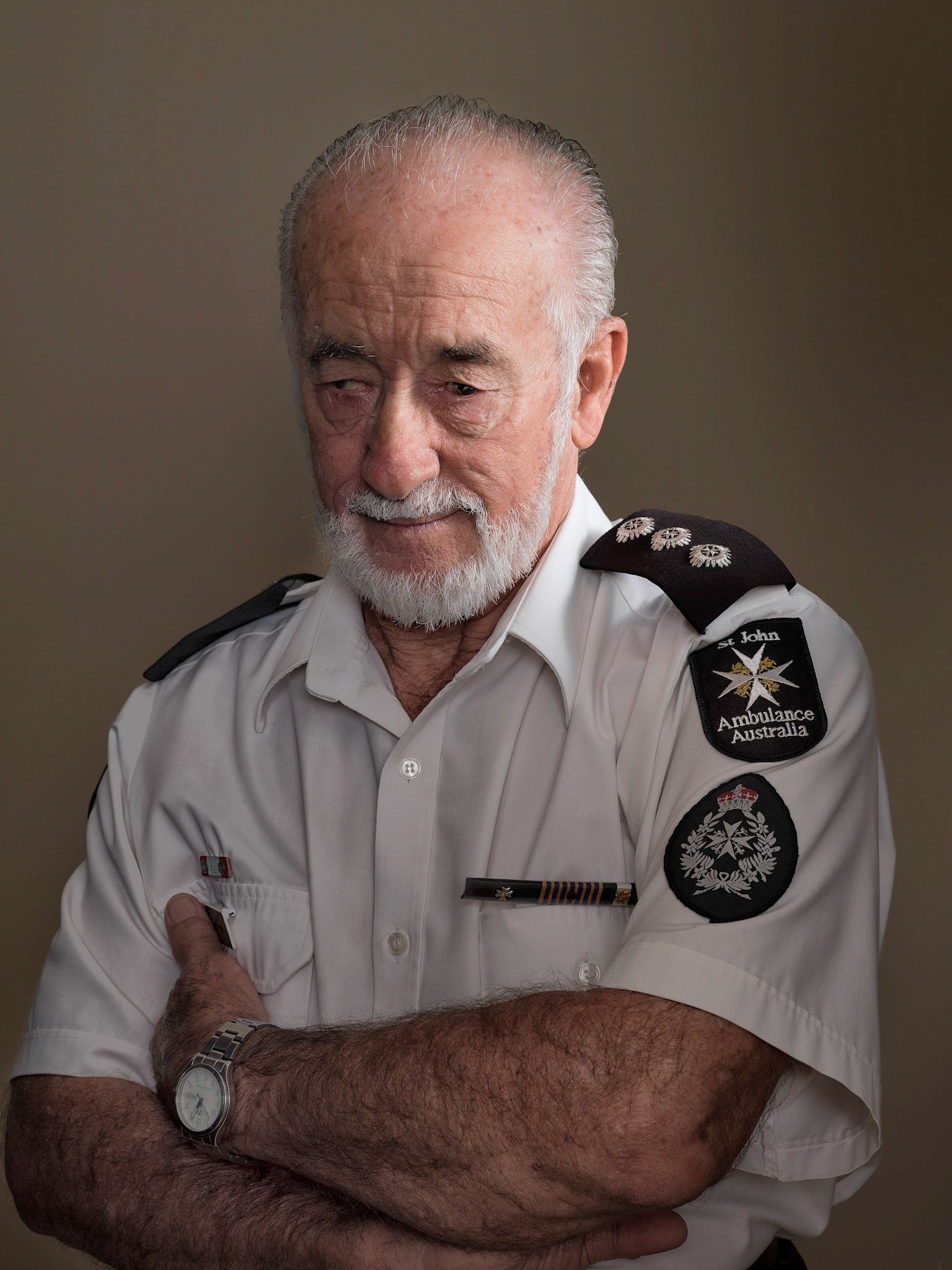 I met Danny when I was shooting the winners of Volunteer of the Year. What struck me was his commitment to providing care. He was a paramedic before an accident left him unable to work. That didn't stop him though. He volunteers for the St John Ambulance Service and the Uniting Church. He provides first aid services and classes to the public as well as being Superintendent of the Singleton Cadet Division where he teaches discipline, parade drill, and first aid, and has been a key person in changing so many young people's lives.This photo was selected for the finals of the National Photographic Portrait Prize 2014. I had the pleasure of inviting Danny and his wife to view his portrait on the opening night of the show in the  National Portrait Gallery Canberra. Standing next to him watching his reaction looking at his portrait hanging in the gallery was an especially rewarding moment for me personally.