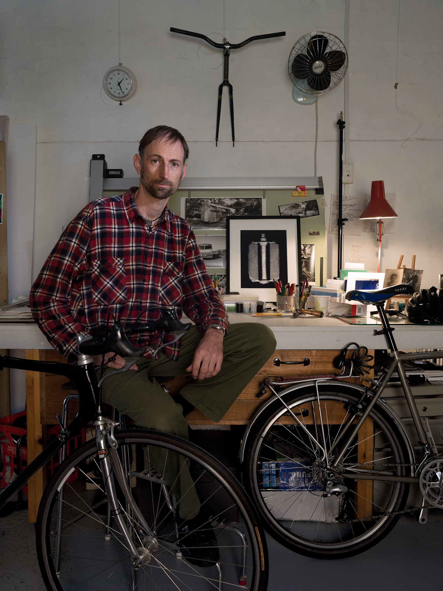 One of the main reasons that I like to take portraits of people in their own spaces is that there’s a lot of their personality in the places where they live and work. This portrait was taken in Mike’s studio which at the time was a mix of a photography studio and a workshop where he tinkered with bicycle parts and made jewellery made from bicycle parts.I haven’t been there in a while but I suspect that knowing Mike a lot would have changed in his workshop/studio by now.