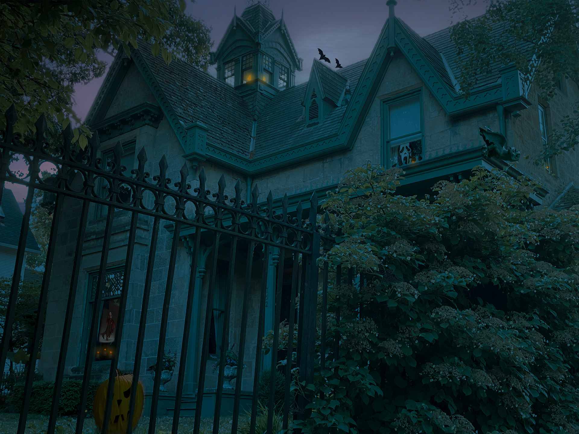 A Haunted House with bats, a pumpkin, and a gargoyle