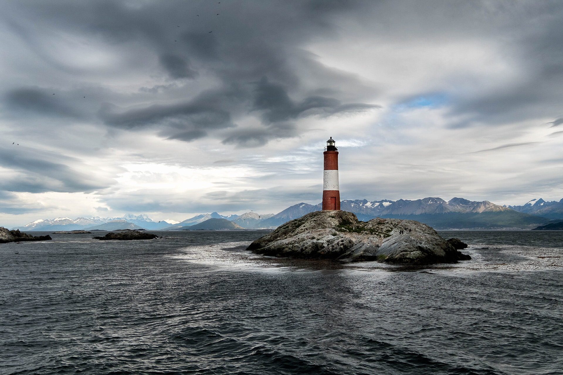 CLOUDY LES ECLAIREUS - Iconic lighthouse undert a cloudy sky, over the border limits between Argentina and Chile, located at the Beagle channel and a few miles away from Ushuaia, Tierra del Fuego, Argentina.