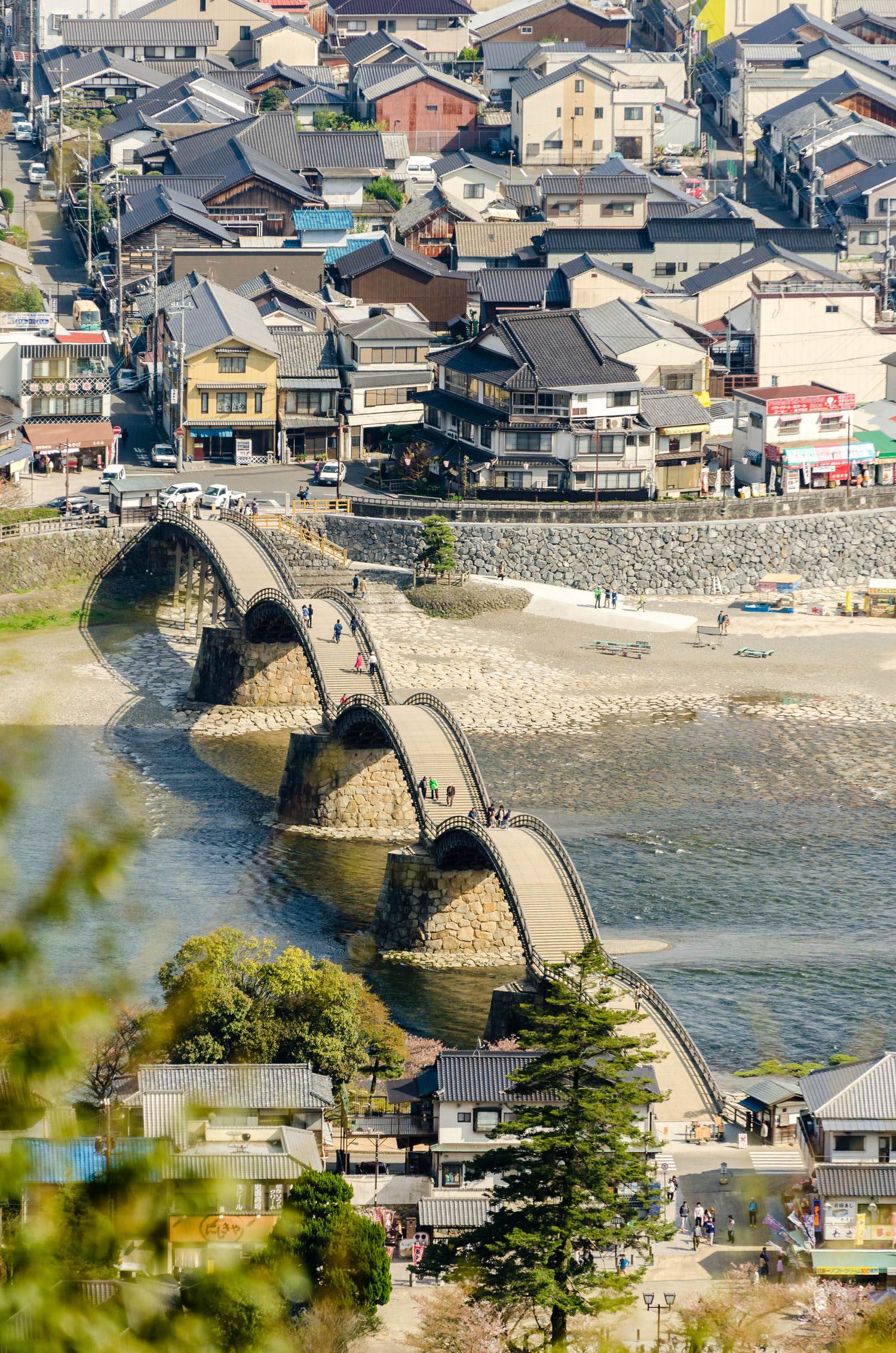 THE OTHER SIDE OF THE BRIDGE - Kintai Bridge, one of the oldest in Japan, and part of the town of Iwakuni, seen from the top of the Iwakuni Castle. Iwakuni, Yamaguchi Prefecture, Japan.