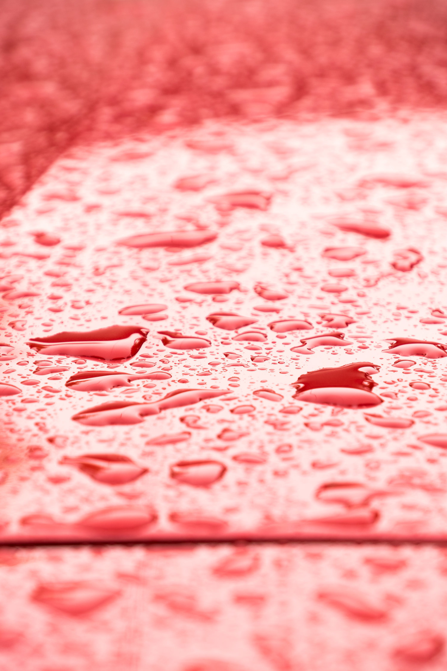 Droplets - Small rain drops over a red car. Juan Lacaze, Colonia, Uruguay