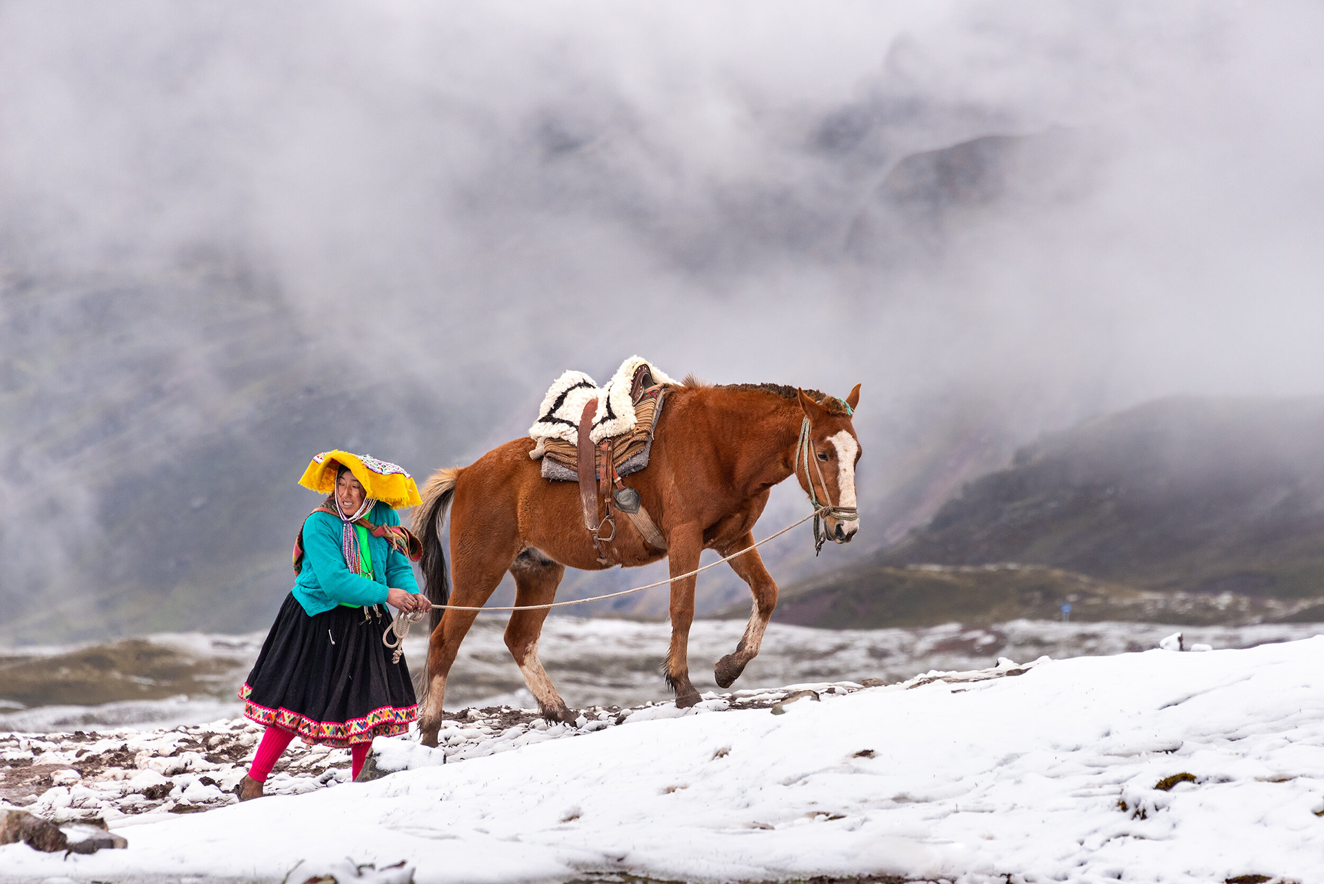 RAINBOW PEOPLE - During my visit to Cusco, my wife and I booked a tour to the Rainbow Mountain. After one hour and a half of bus trip, we starter the hike at 4600 mts height. After almost 3 hours we finally reached the summit. Even though we didn't see any colors, it really worth the effort. The true experience was to stare at amazing snowcapped landscapes and see the locals with their colorful outfits living on that extreme place of the earth.  Rainbow Mountain, near Cusco, Perú.