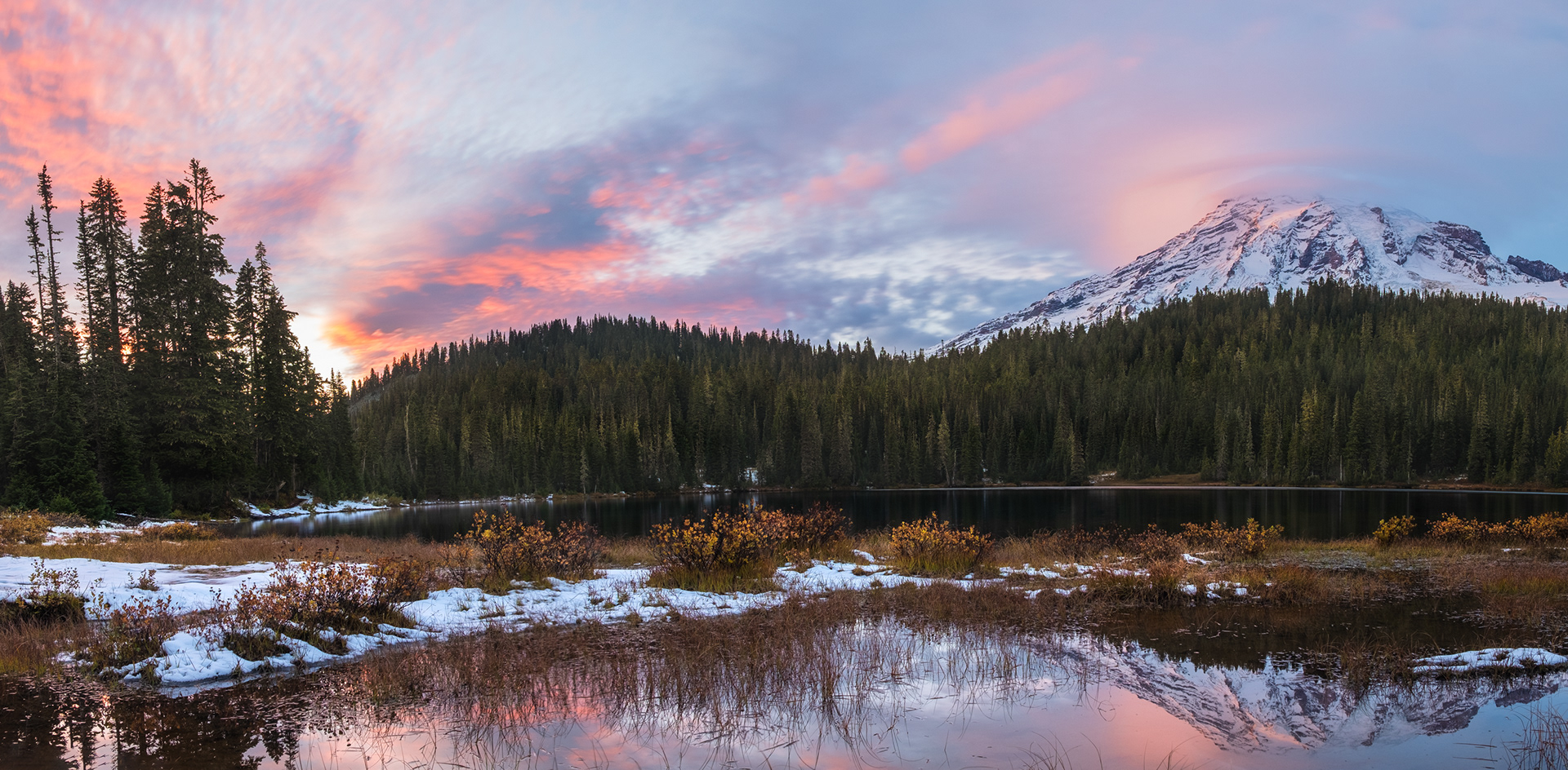 Sunset View - Gorgeous sunset with the reflection of Mount Rainier on the calms waters of a lake at Mount Rainier National Park, Washington State, USA
