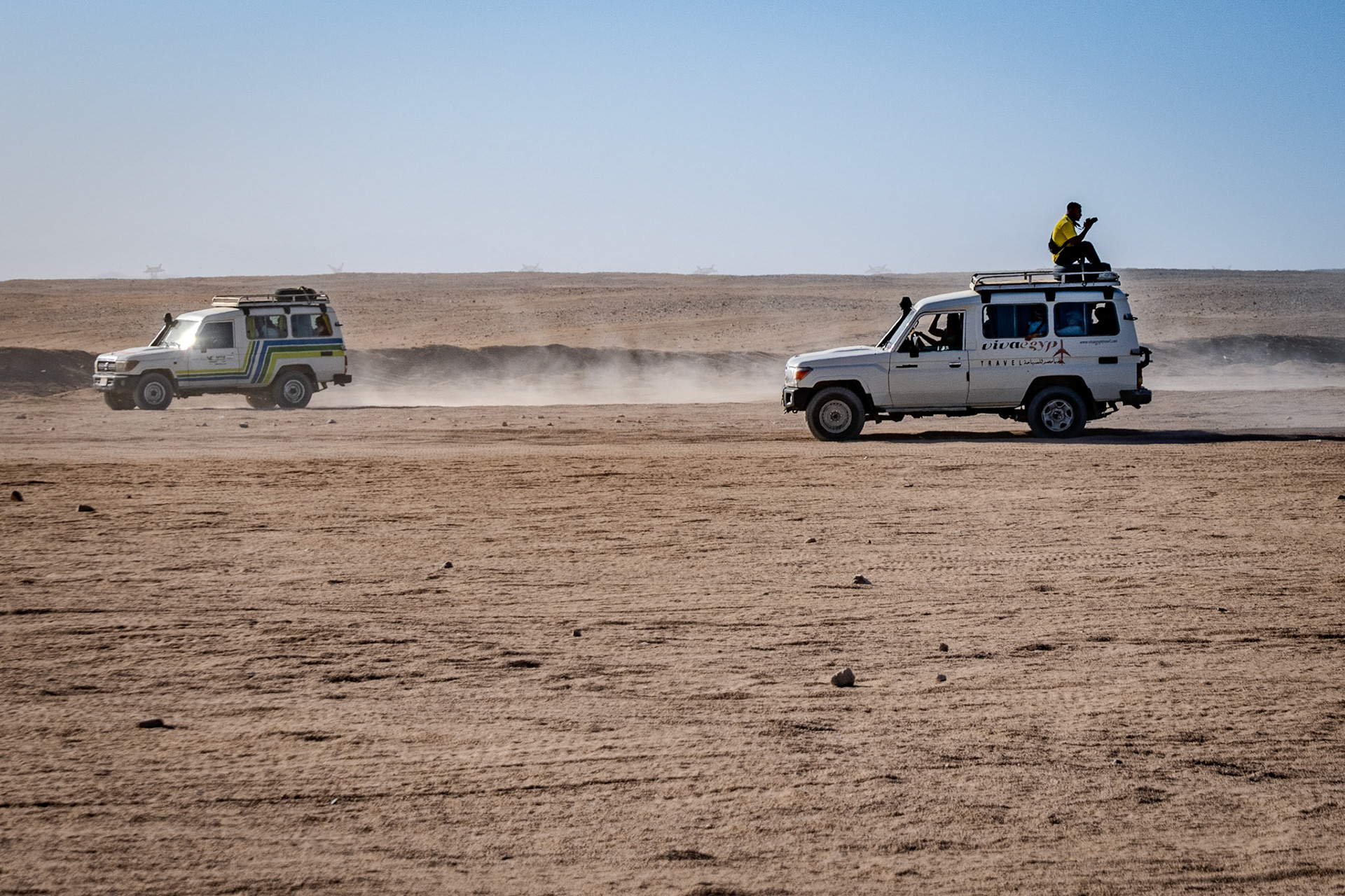 Man on the roof of Desert Safari Vehicle