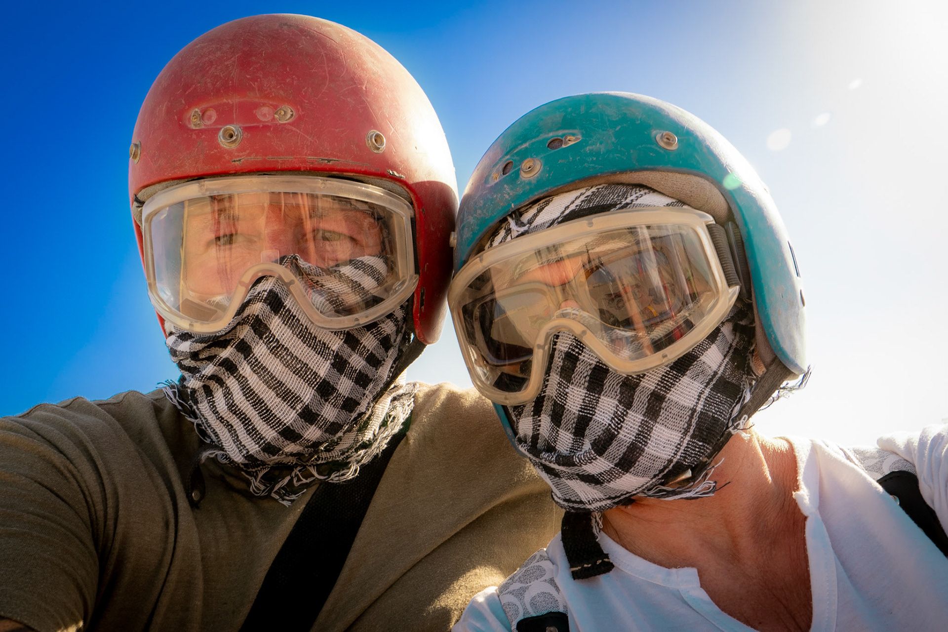 Close up of couple wearing quad bike helmets and goggles