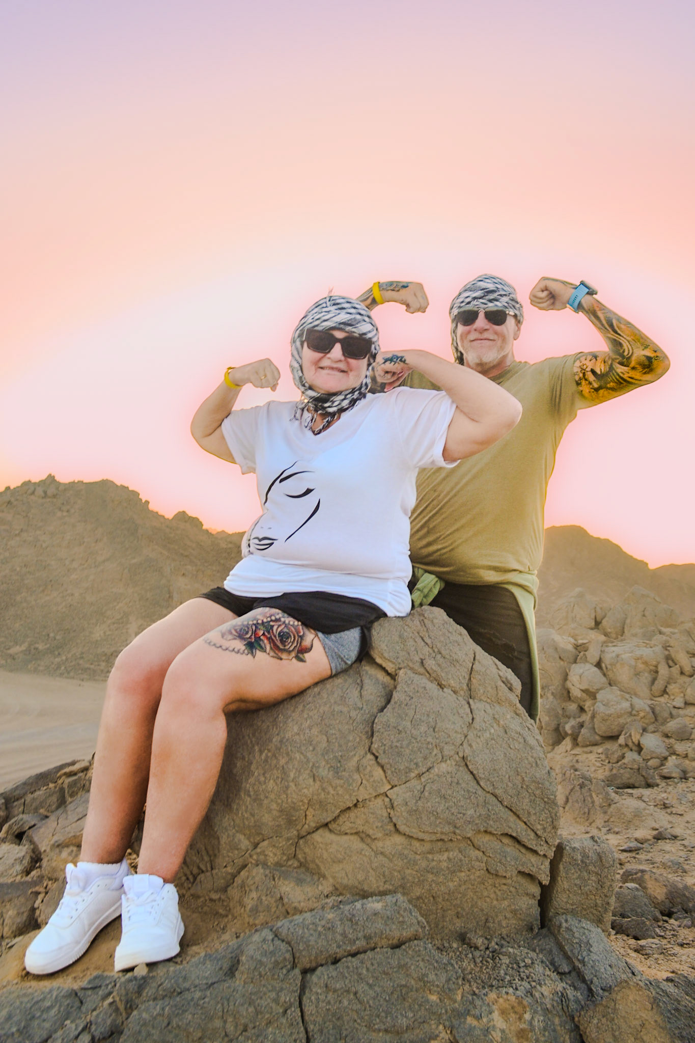 Couple flexing their muscles in the desert