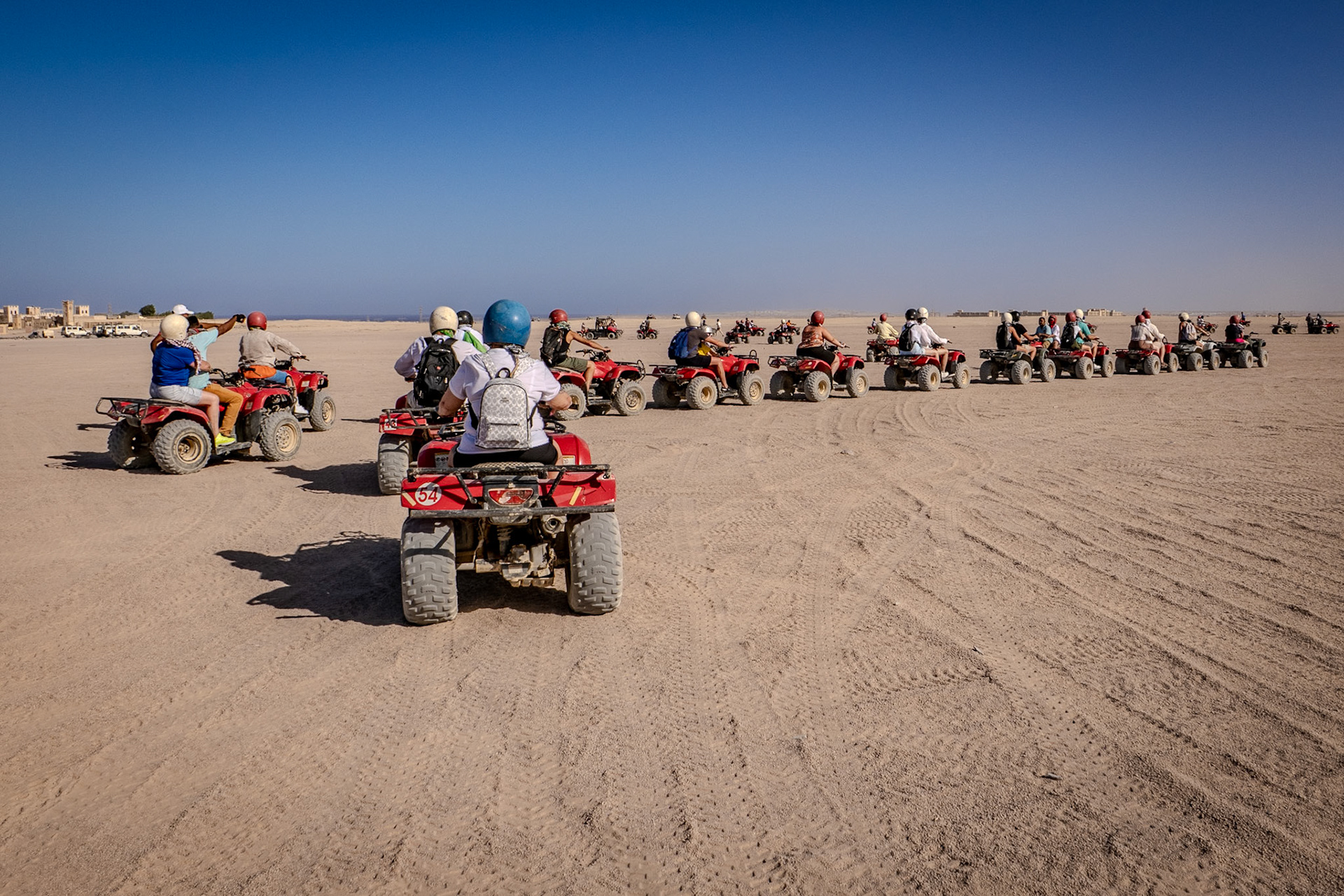 Many people riding on quad biles